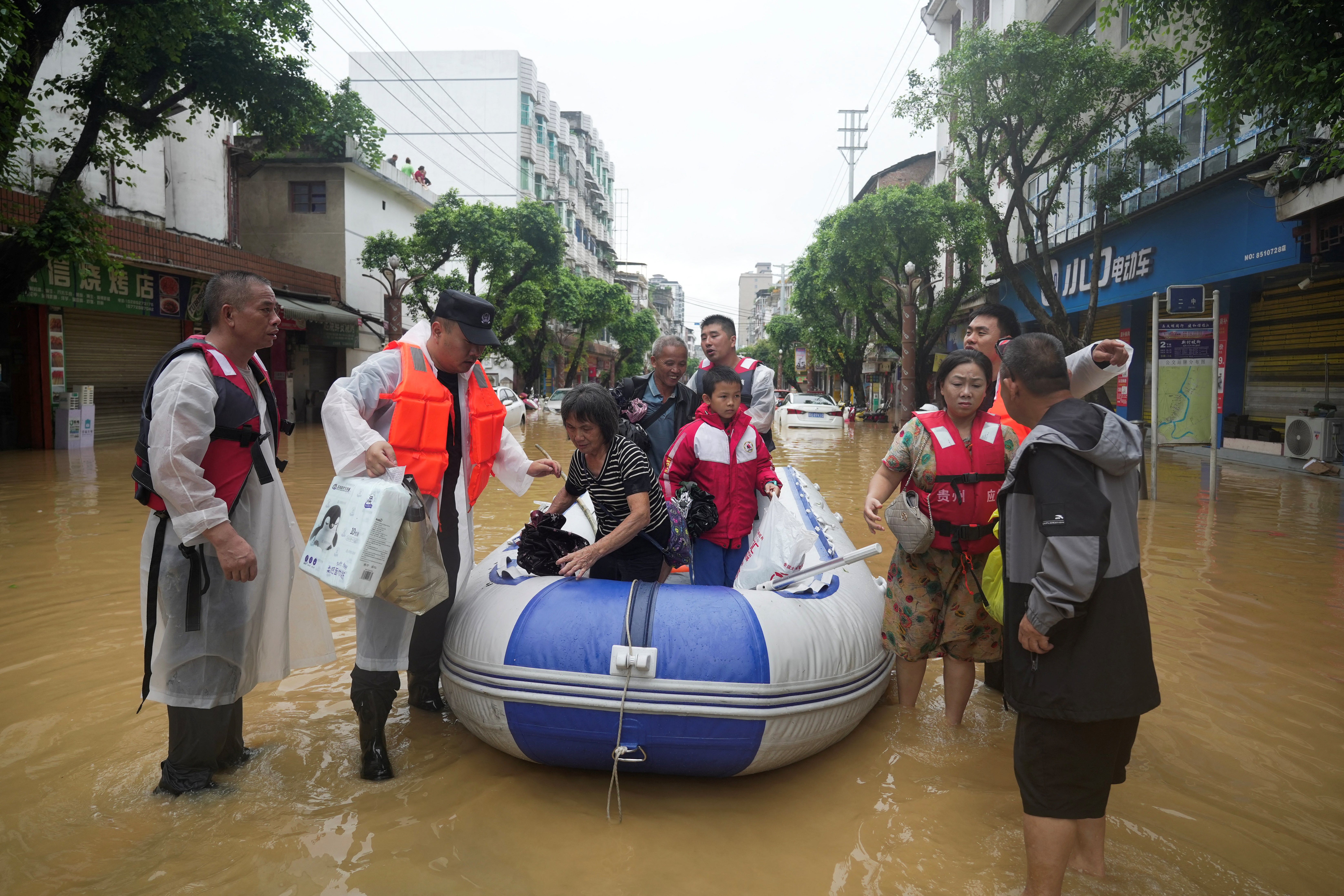 Rescue workers evacuate residents from flooded areas in Rongjiang county of Guizhou province, China, on 24 June 2025