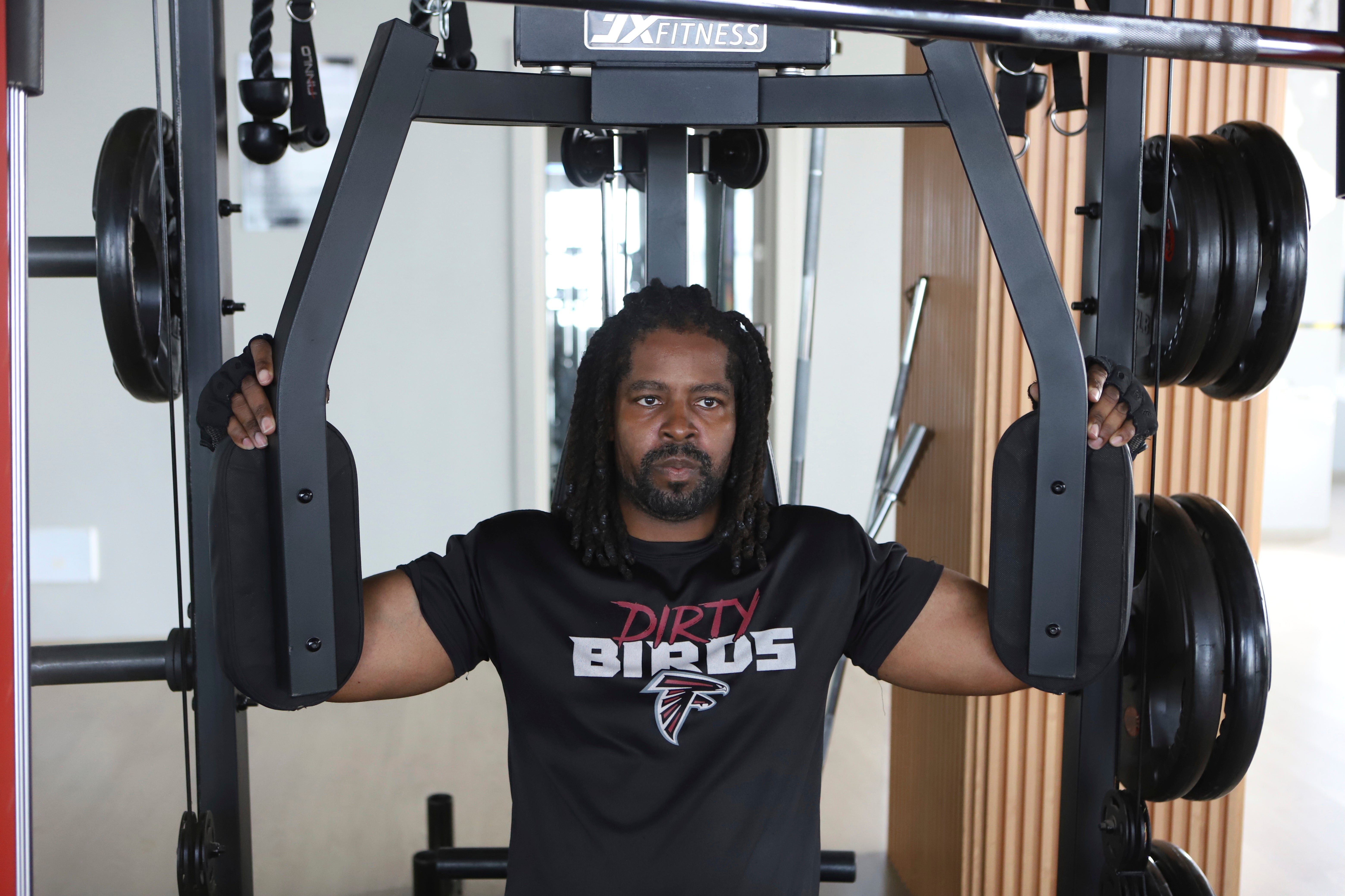 Kenneth Harris, a 38-year-old retired veteran, lifts weights at a gym in Nairobi, Kenya, Friday, May 23, 2025. (AP Photo/Andrew Kasuku)