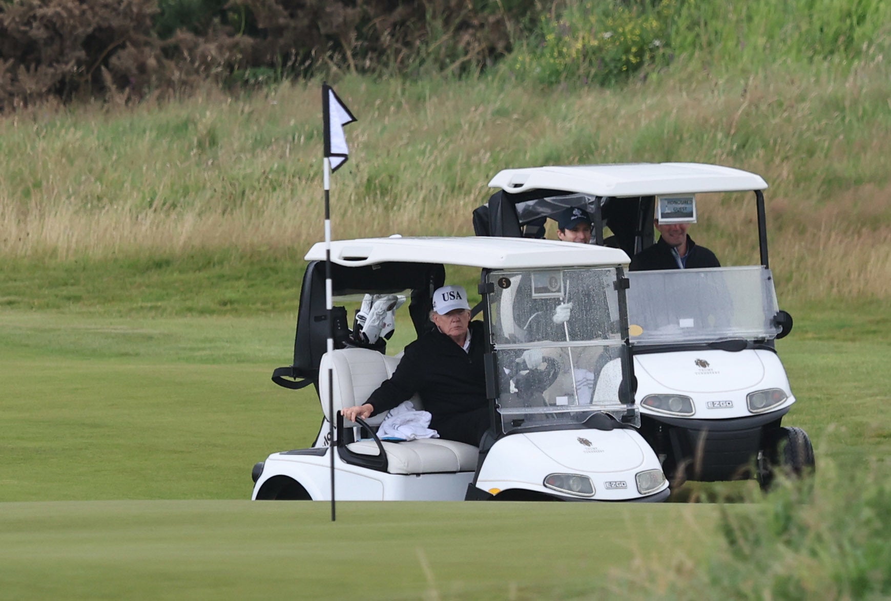 US President Donald Trump steers a golf cart at his Trump Turnberry golf course in South Ayrshire (Robert Perry/PA)