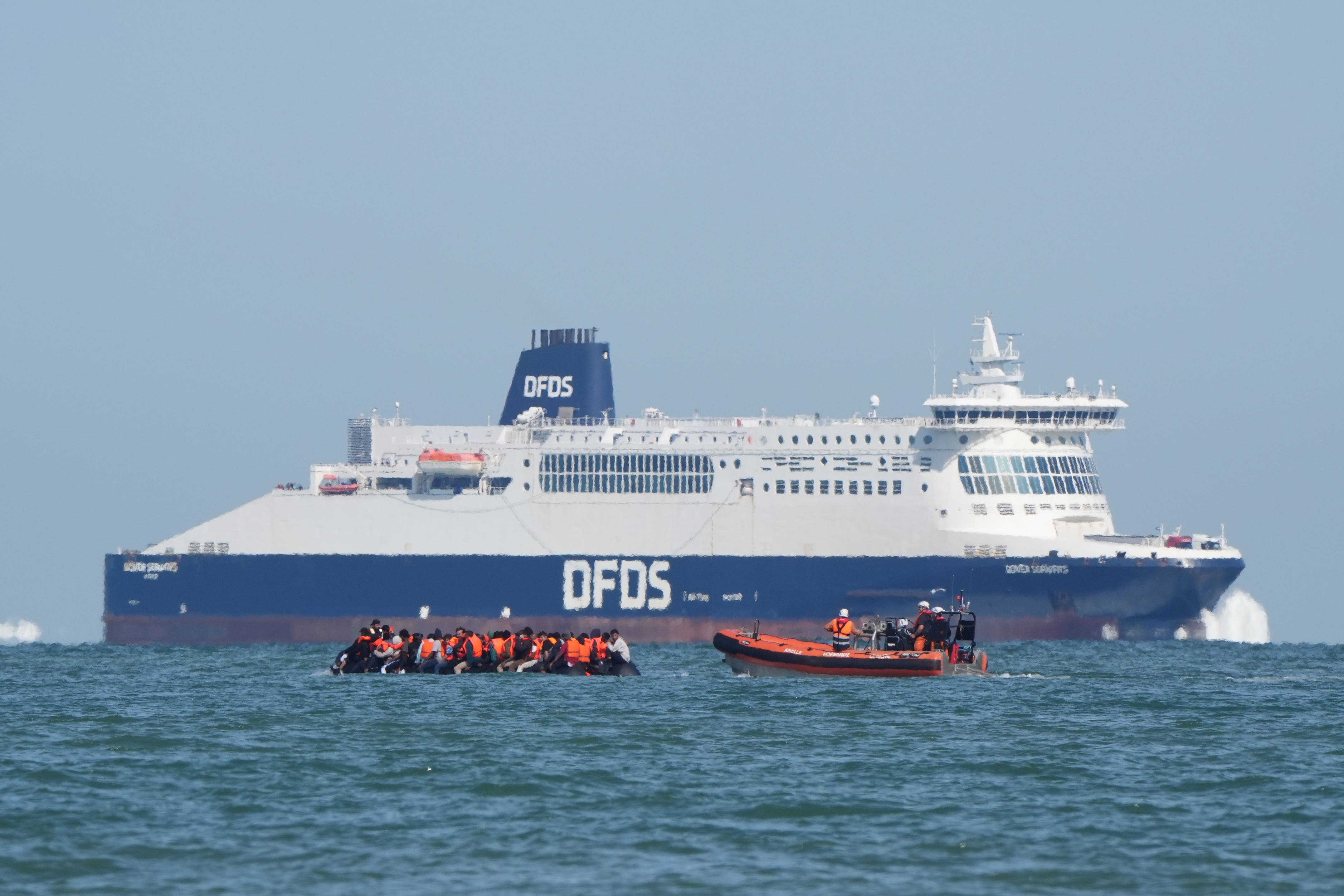 <p>A boat intercepts people thought to be migrants off the coast of Calais</p>