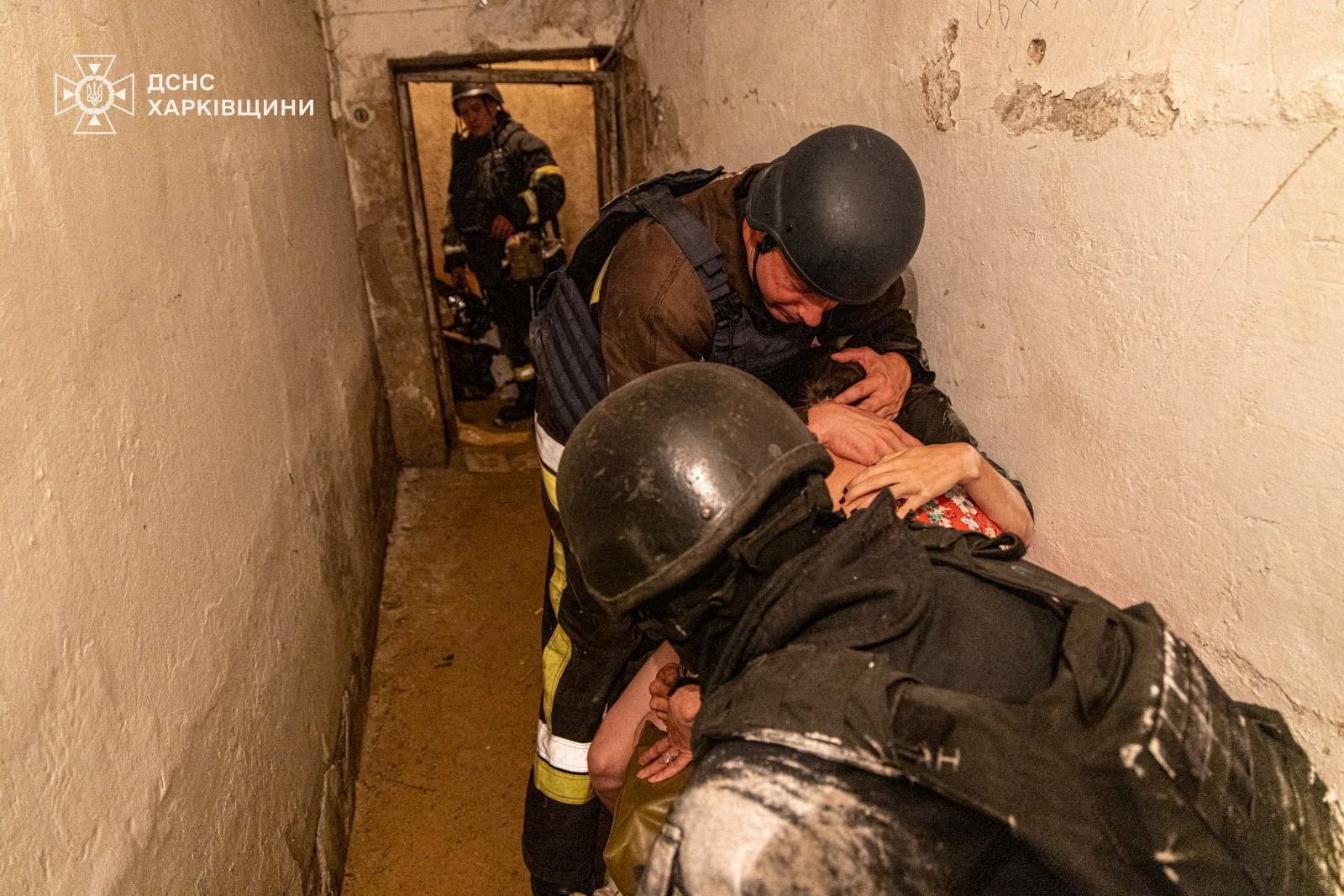 People take shelter in a residential building in Kharkiv