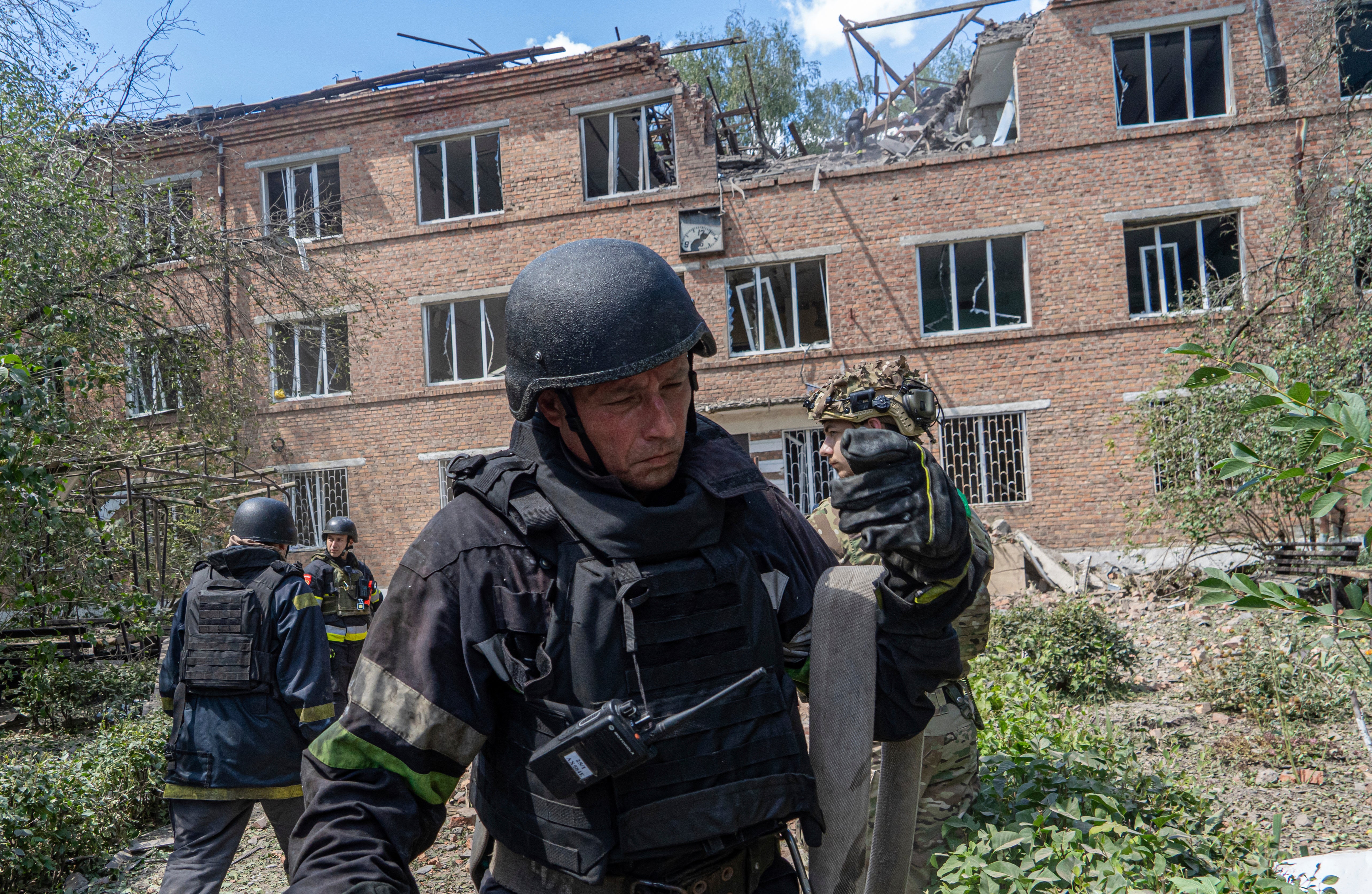 Rescuers work at a damaged city hospital that was hit by a Russian guided air bomb in Kharkiv