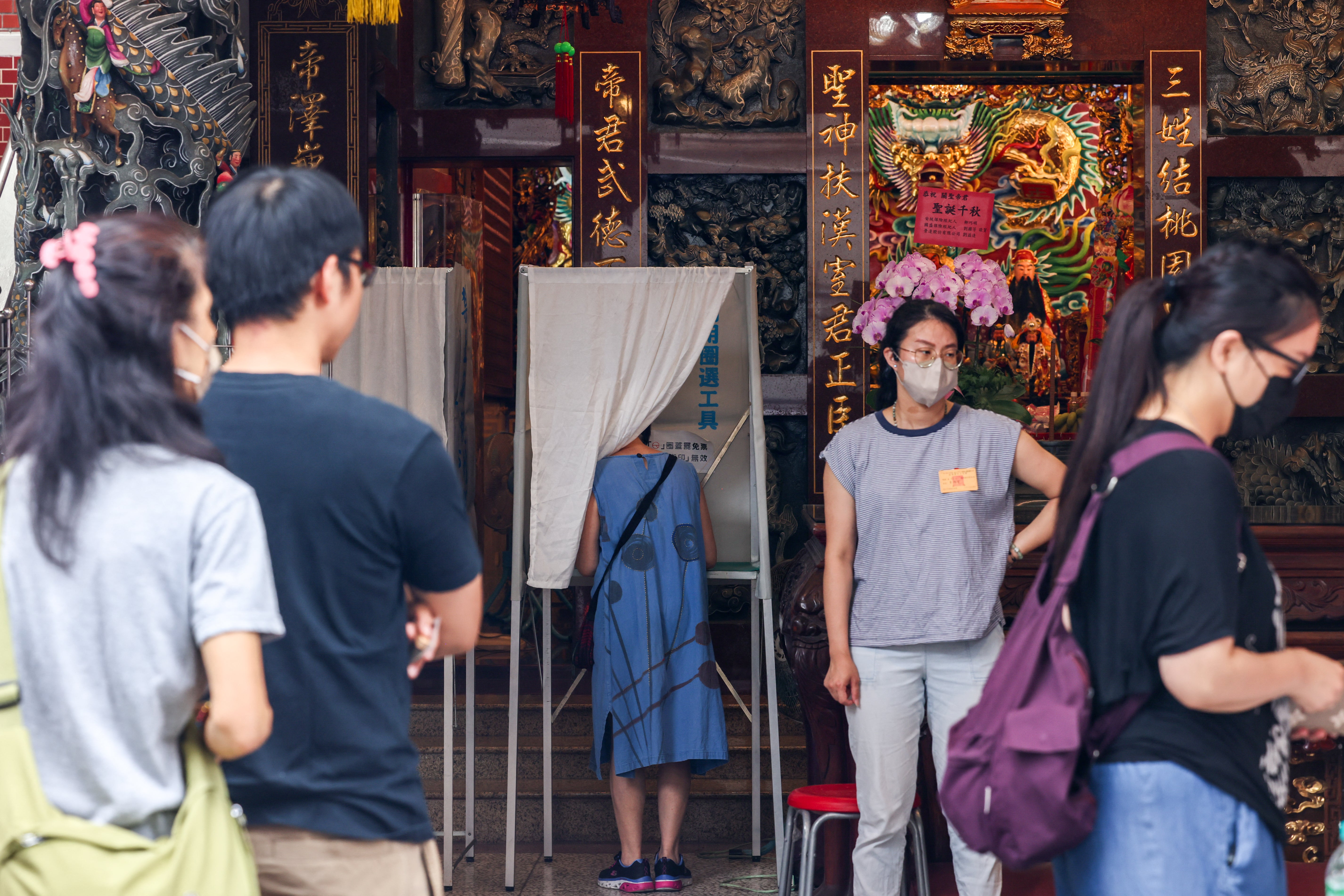 People vote at a local temple used a polling station during the recall election in Taipei on July 26, 2025