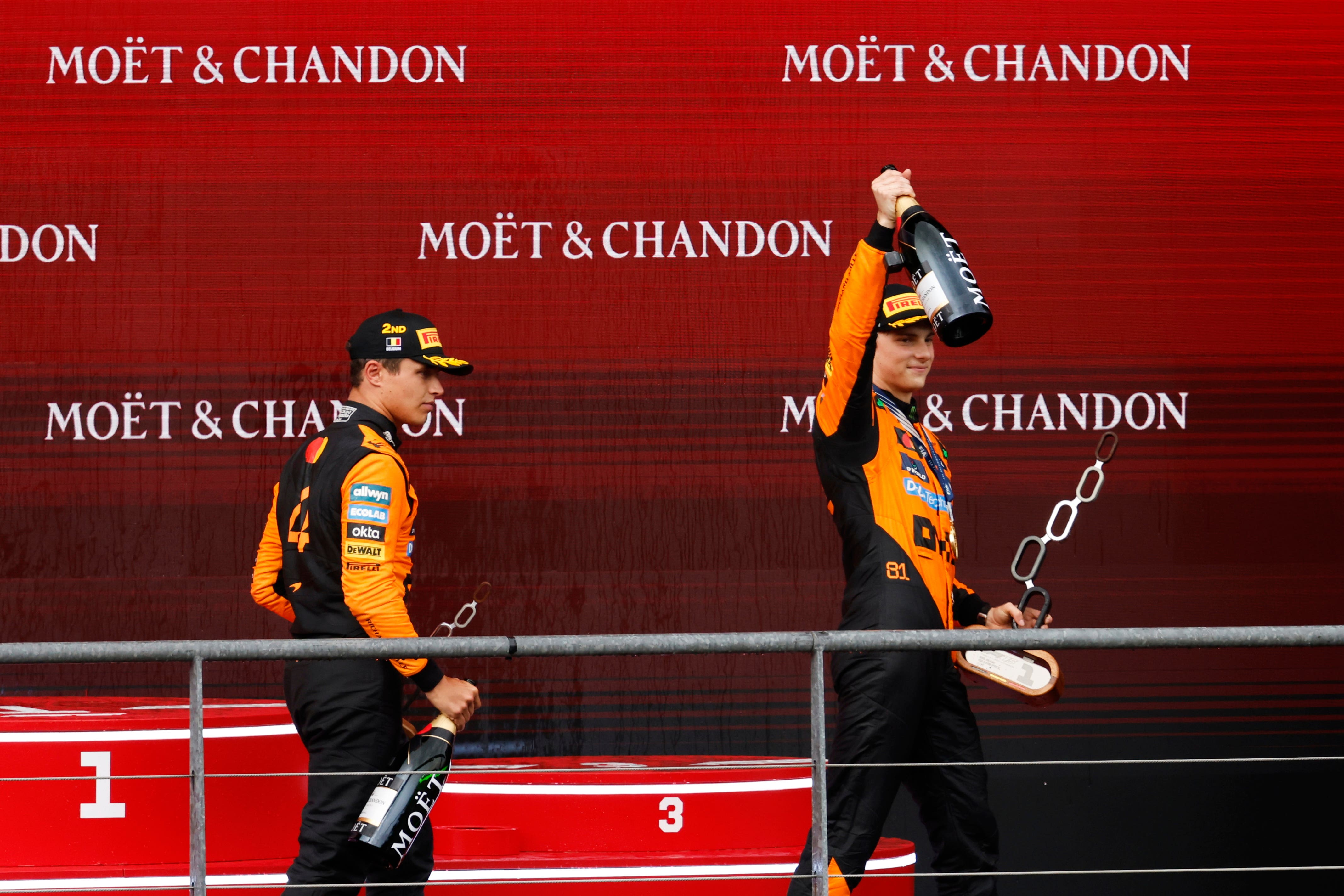 McLaren’s Oscar Piastri, right, celebrates on the podium with his second-placed team-mate Lando Norris (Geert Vanden Wijngaert/AP)