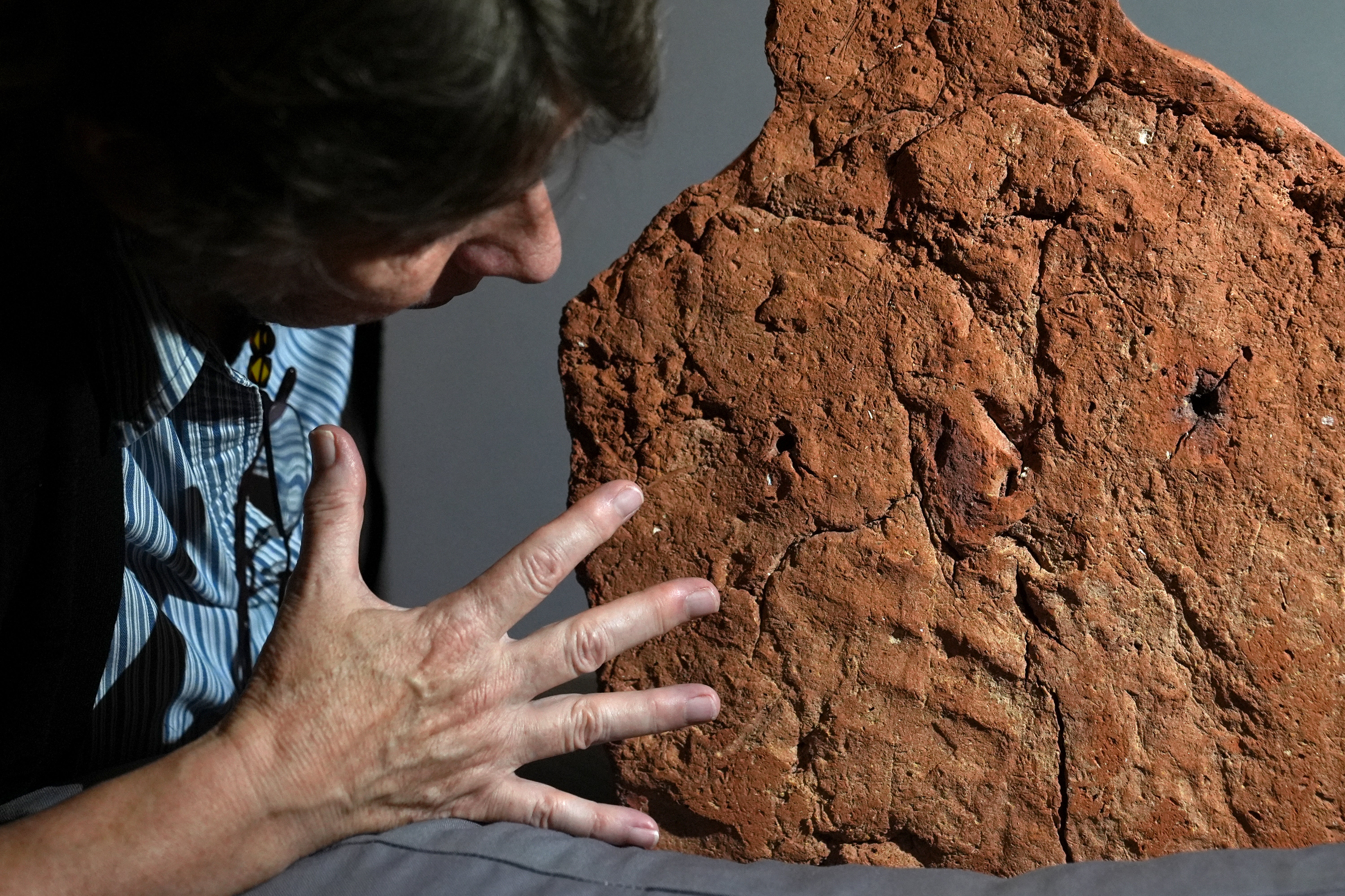 Helen Strudwick, curator of Made in Ancient Egypt, views a 4,000-year-old ancient Egyptian handprint discovered on a 'soul house' at the Fitzwilliam Museum in Cambridge ahead of their forthcoming exhibition Made in Ancient Egypt opening in October. Researchers at the Cambridge University museum found the handprint on the base of the 'soul house'.