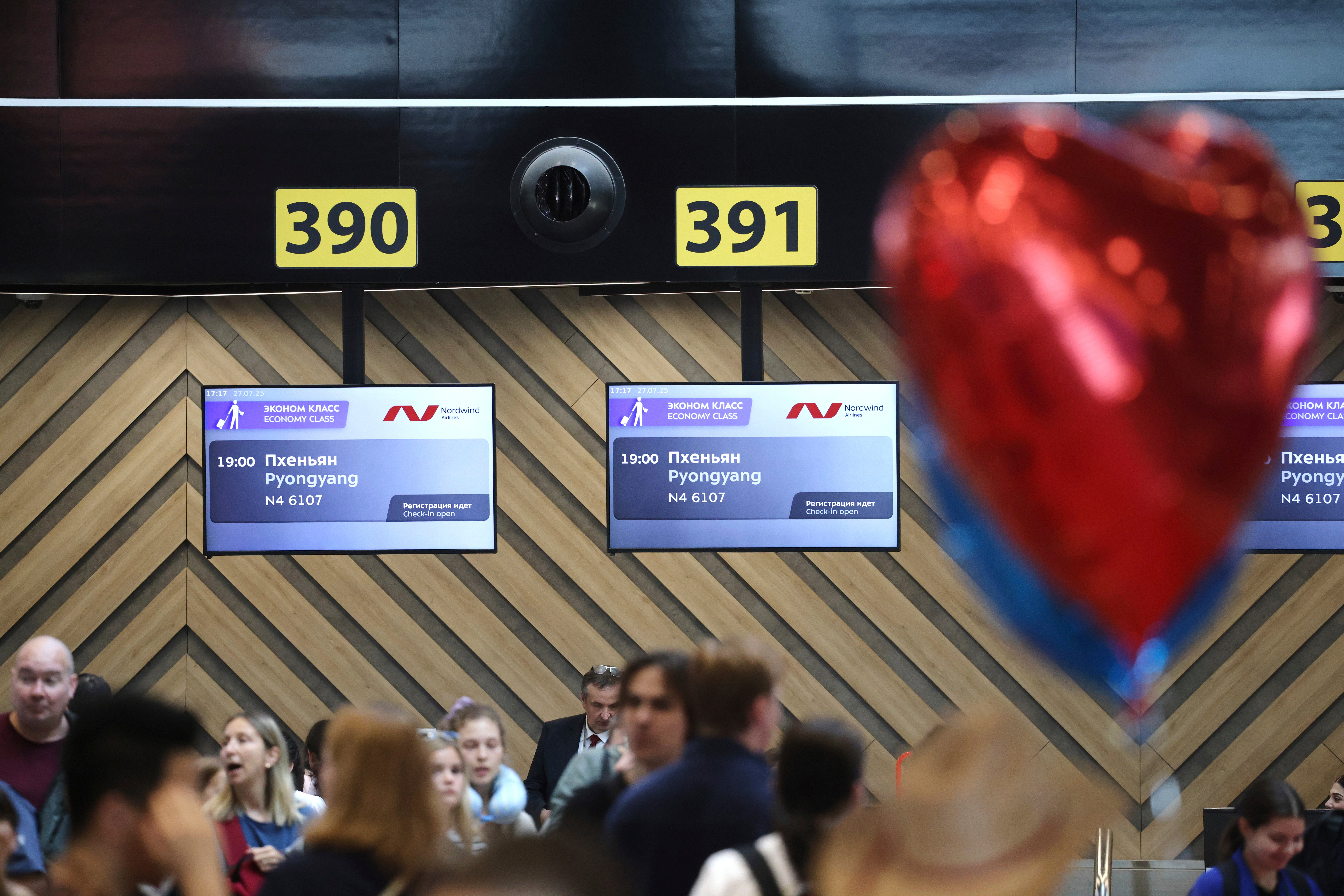Passengers lineup to check-in for the first flight connecting Moscow and Pyongyang at Moscow's Sheremetyevo International airport amidst the warming relations between Russia and North Korea outside Moscow, Russia, Sunday, July 27, 2025. (AP Photo)