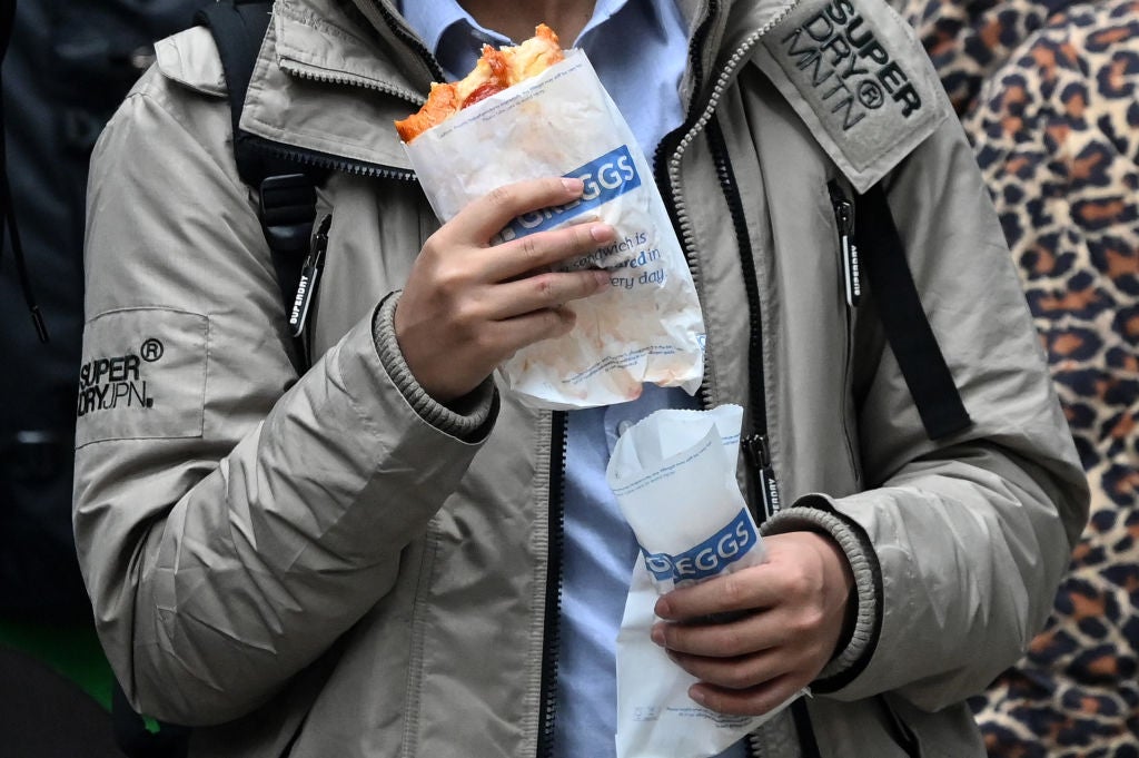 A customer carries take-away purchase after leaving a Greggs bakery in central London on March 5, 2024