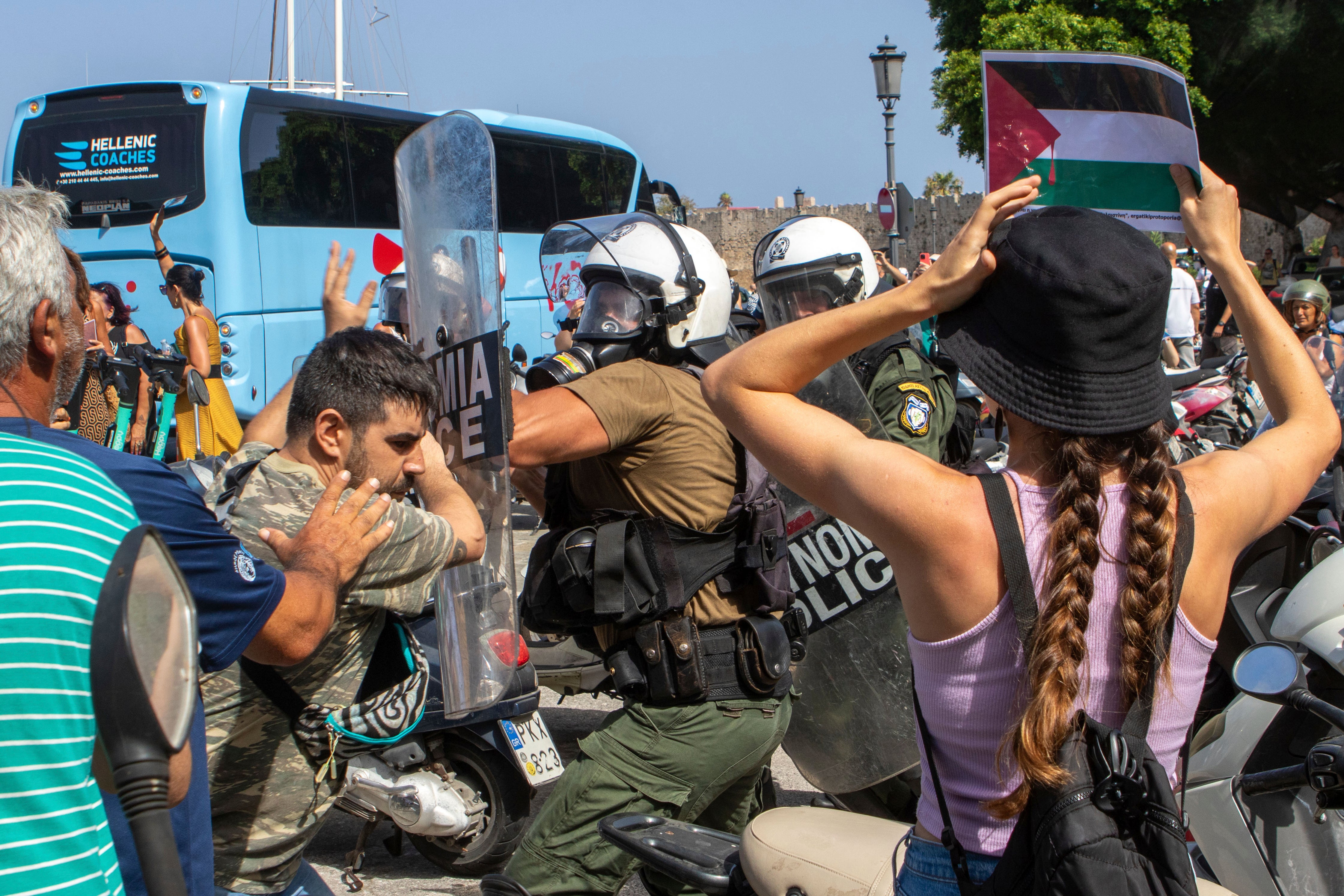 Riot police scuffle with demonstrators on Greek island during visit by Israeli cruise ship