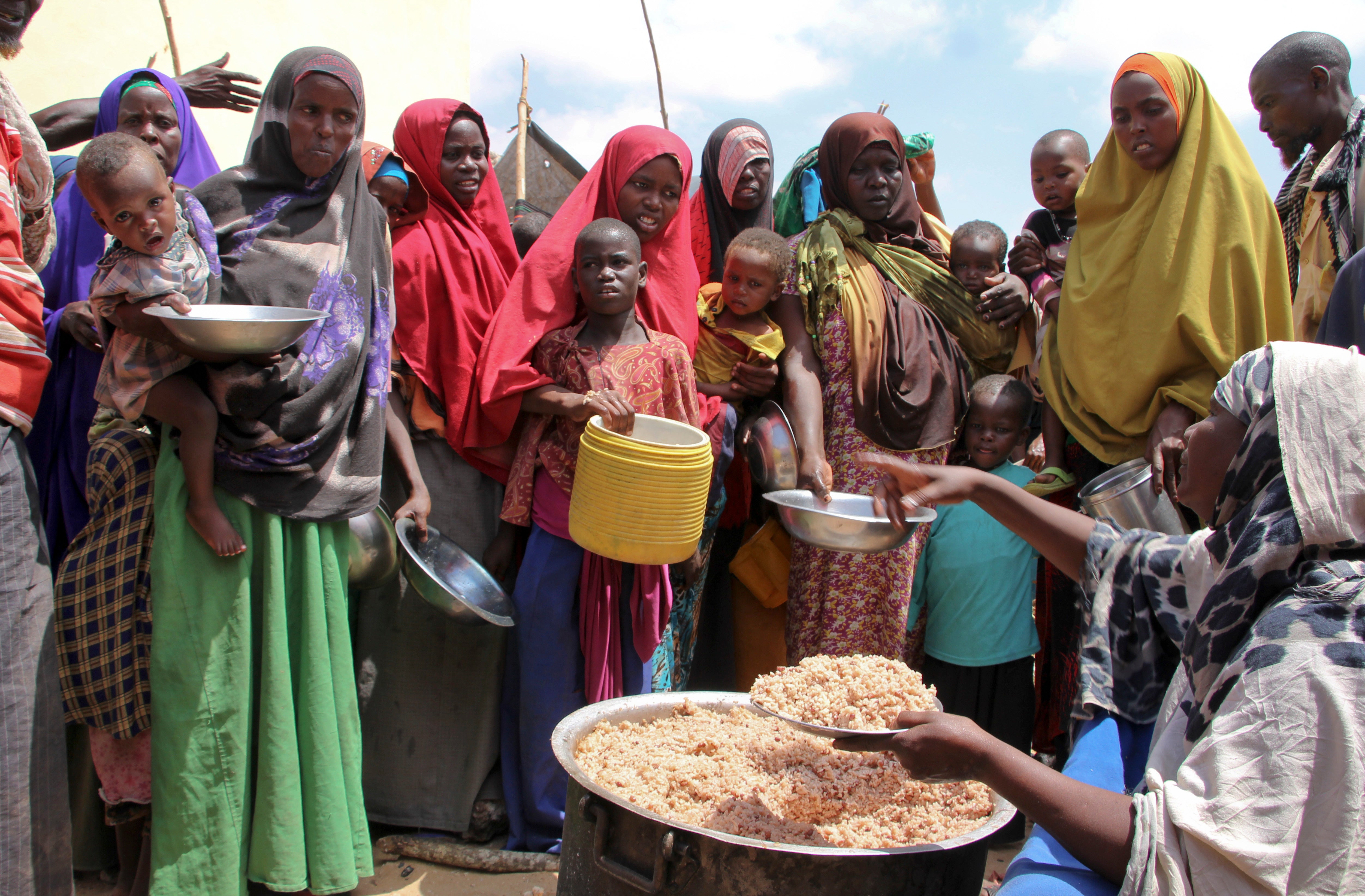 Somalis displaced by drought receive food at makeshift camps in Tabelaha on the outskirts of Mogadishu