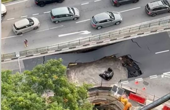 A large sinkhole engulfed a black Mazda over the weekend in Singapore