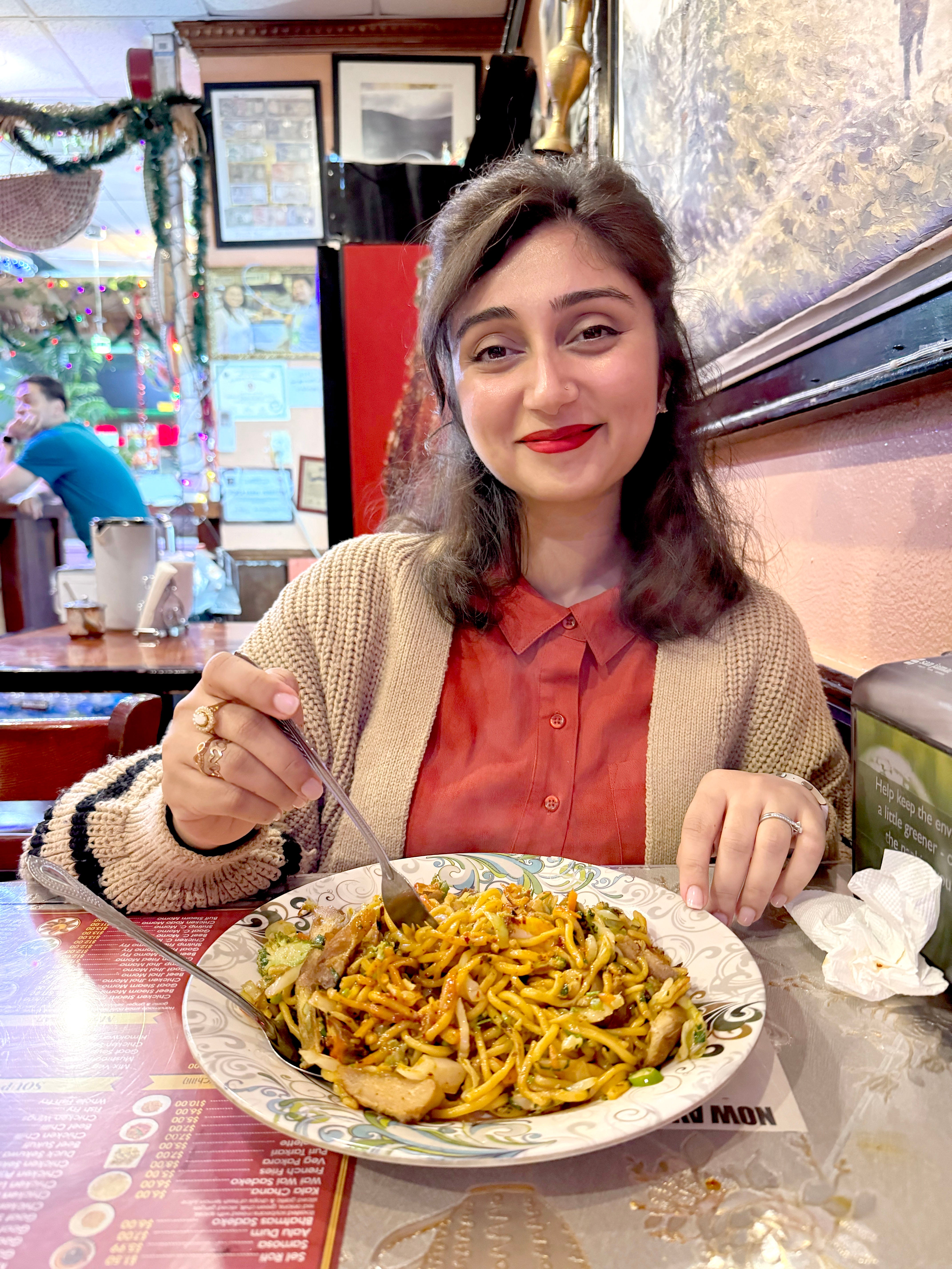 Queenie enjoys vegetarian chowmein at Nepali Bhanchha Ghar in Jackson Heights in Queens