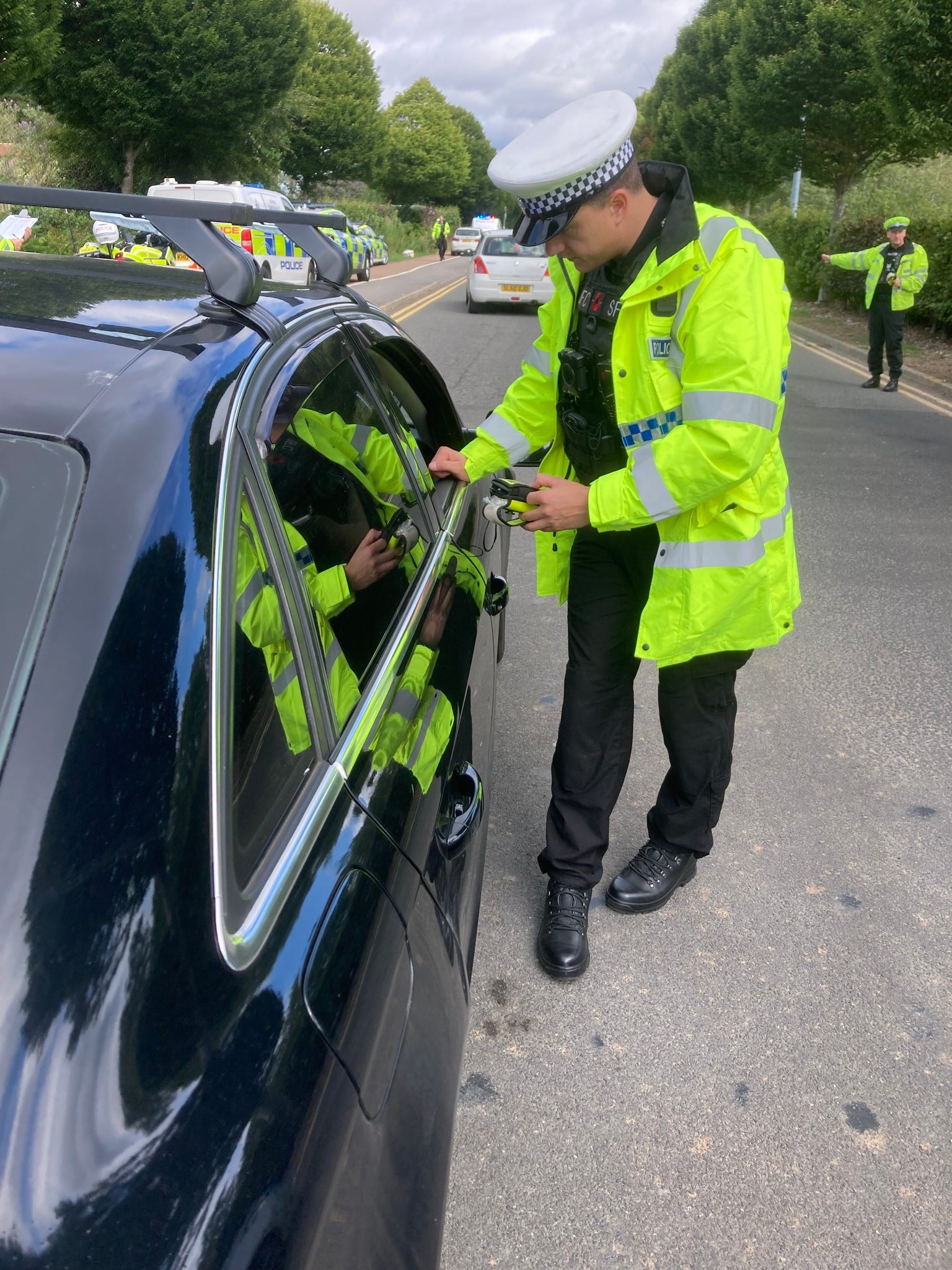 A Durham Constabulary officer breathalyses a holidaymaker leaving Teesside Airport