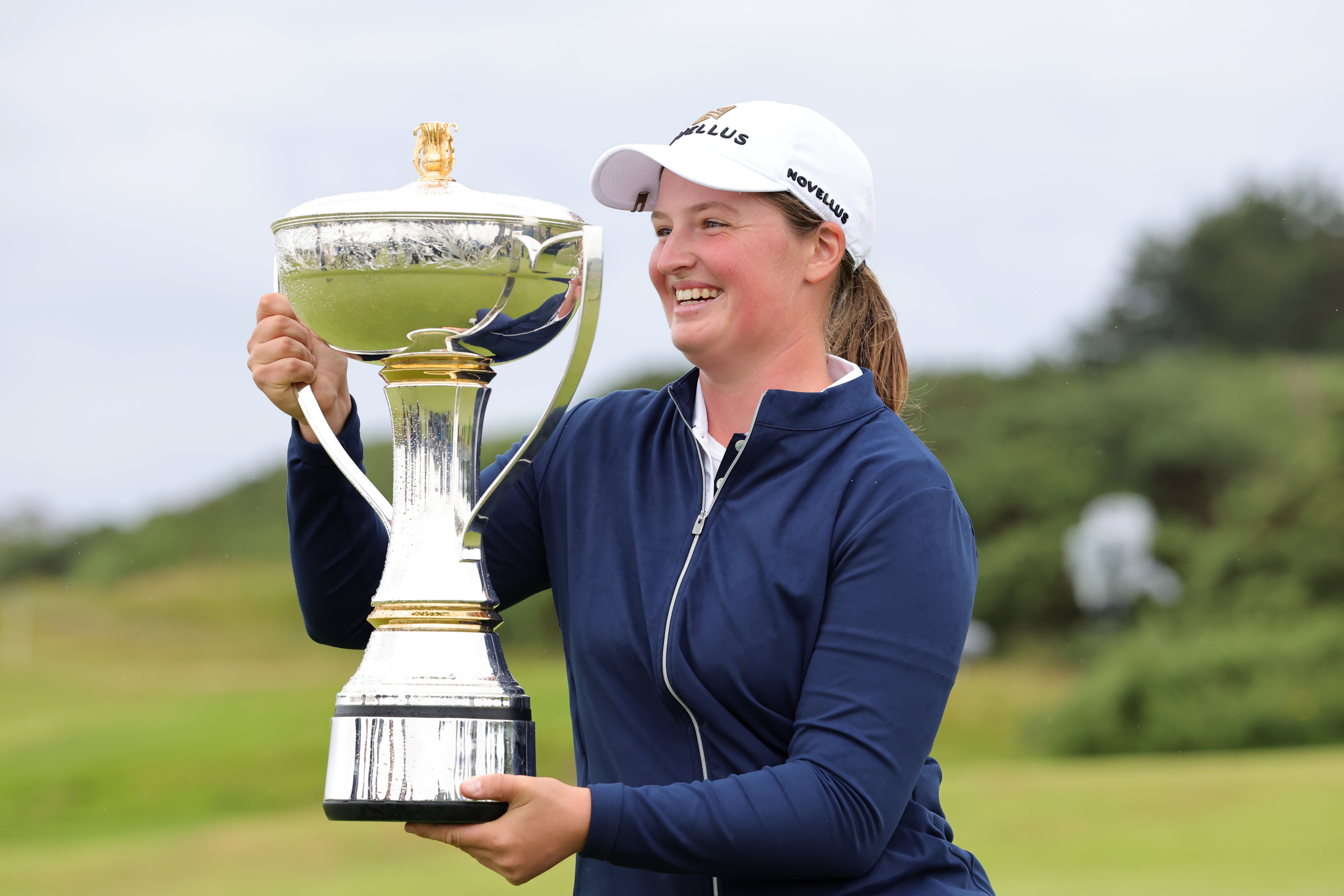England's Lottie Woad holds the trophy after winning the 2025 ISPS HANDA Women's Scottish Open