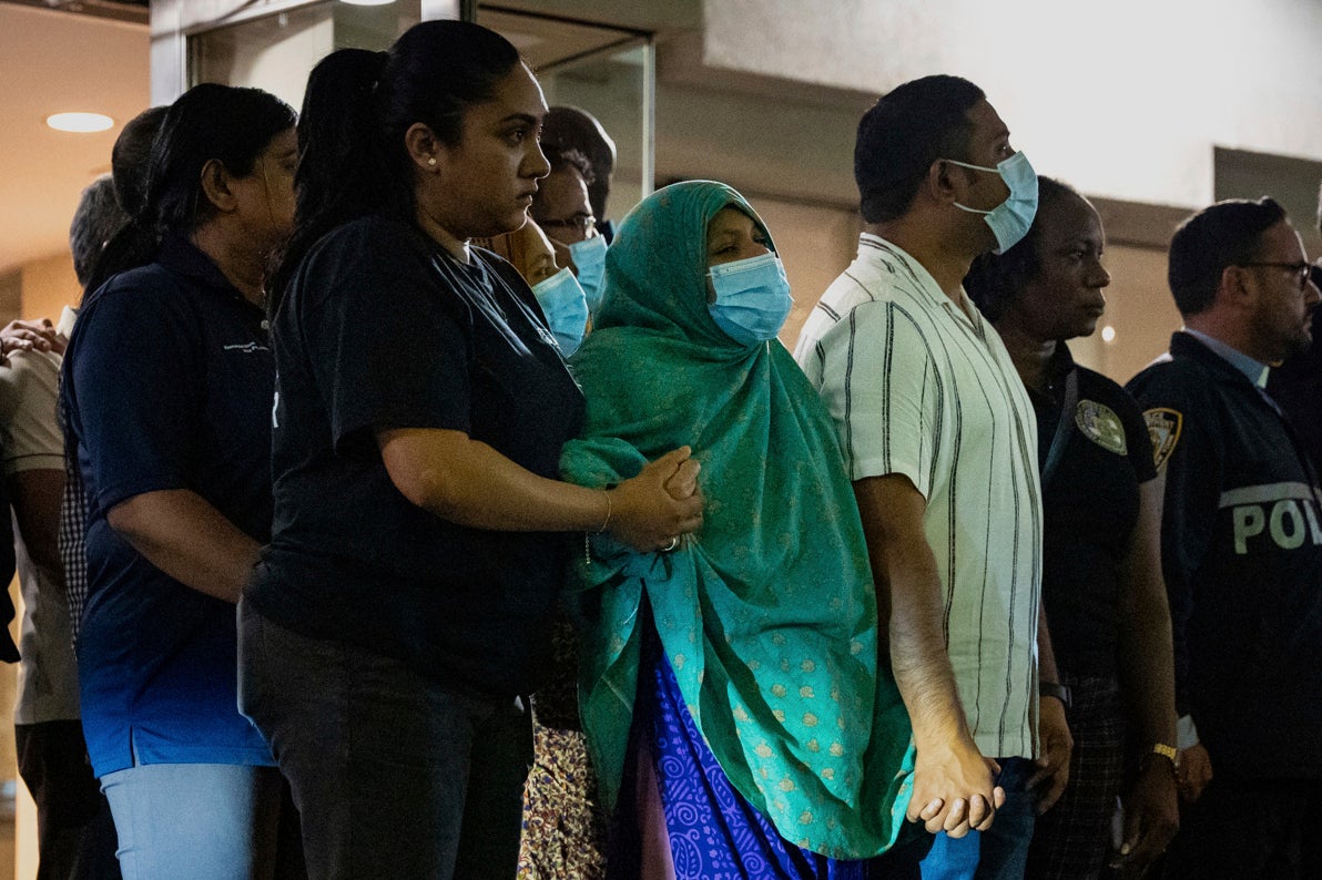 Family and friends of Didarul Islam, who was shot and killed by a gunman Monday evening, watch his dignified transfer out of NewYork-Presbyterian/Weill Cornell Medical Hospital to the medical examiner's office, early Tuesday, July 29, 2025, in New York. (AP Photo/Angelina Katsanis)