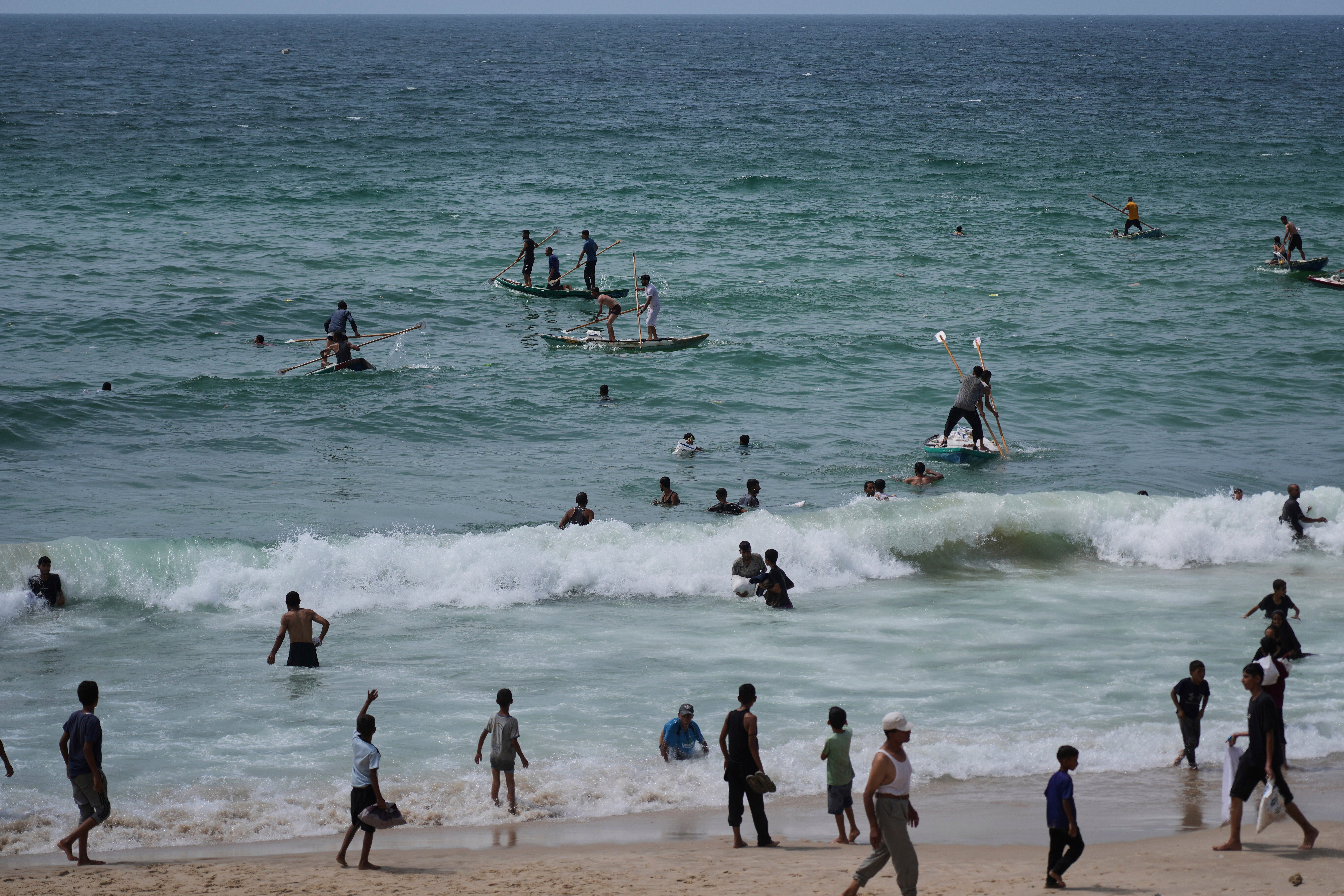 Palestinians search for aid that landed in the Mediterranean Sea after being airdropped over central Gaza (AP Photo/Abdel Kareem Hana)