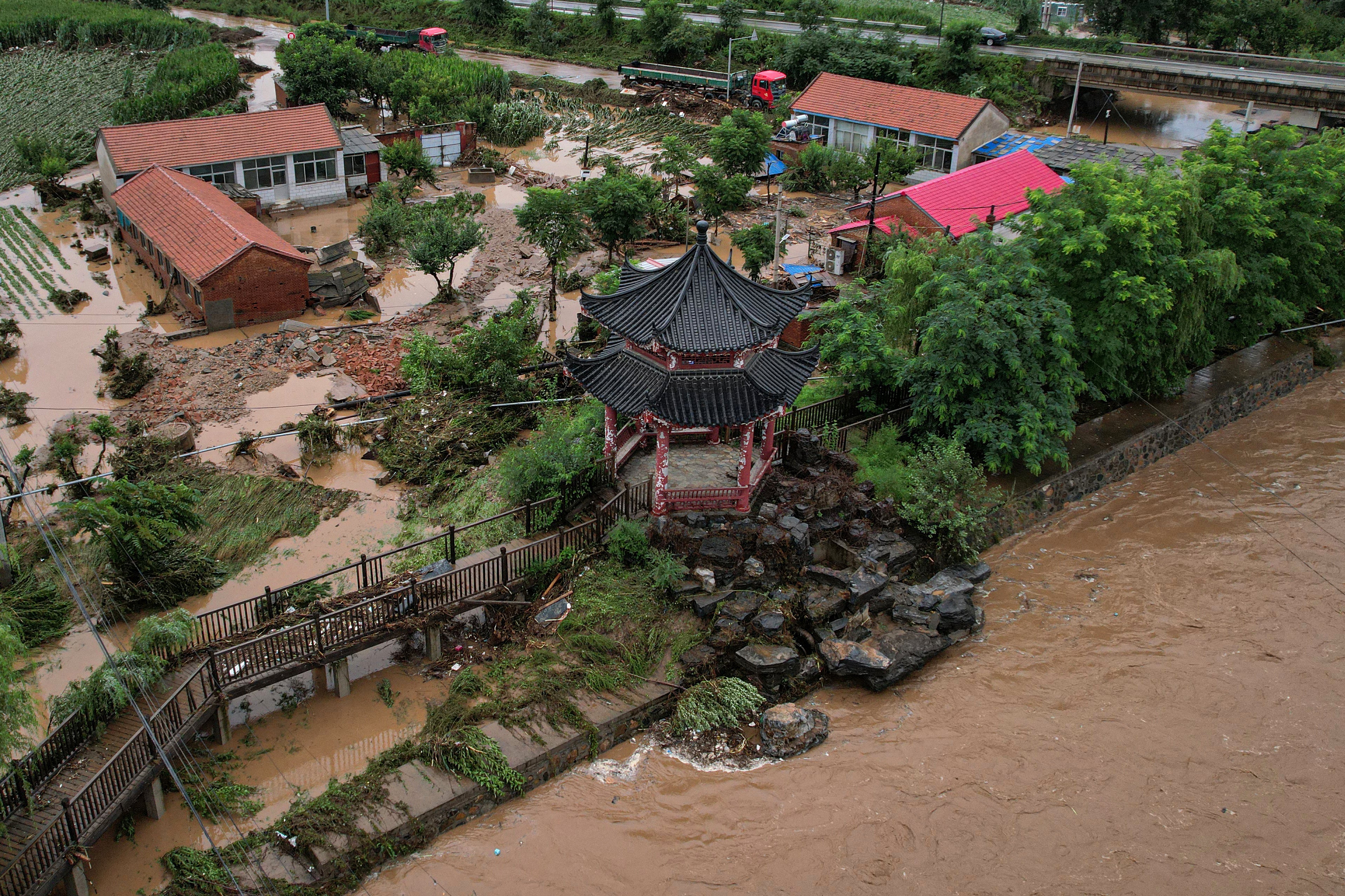 At least 30 dead as almost a year’s worth of rain lashes Beijing in matter of days