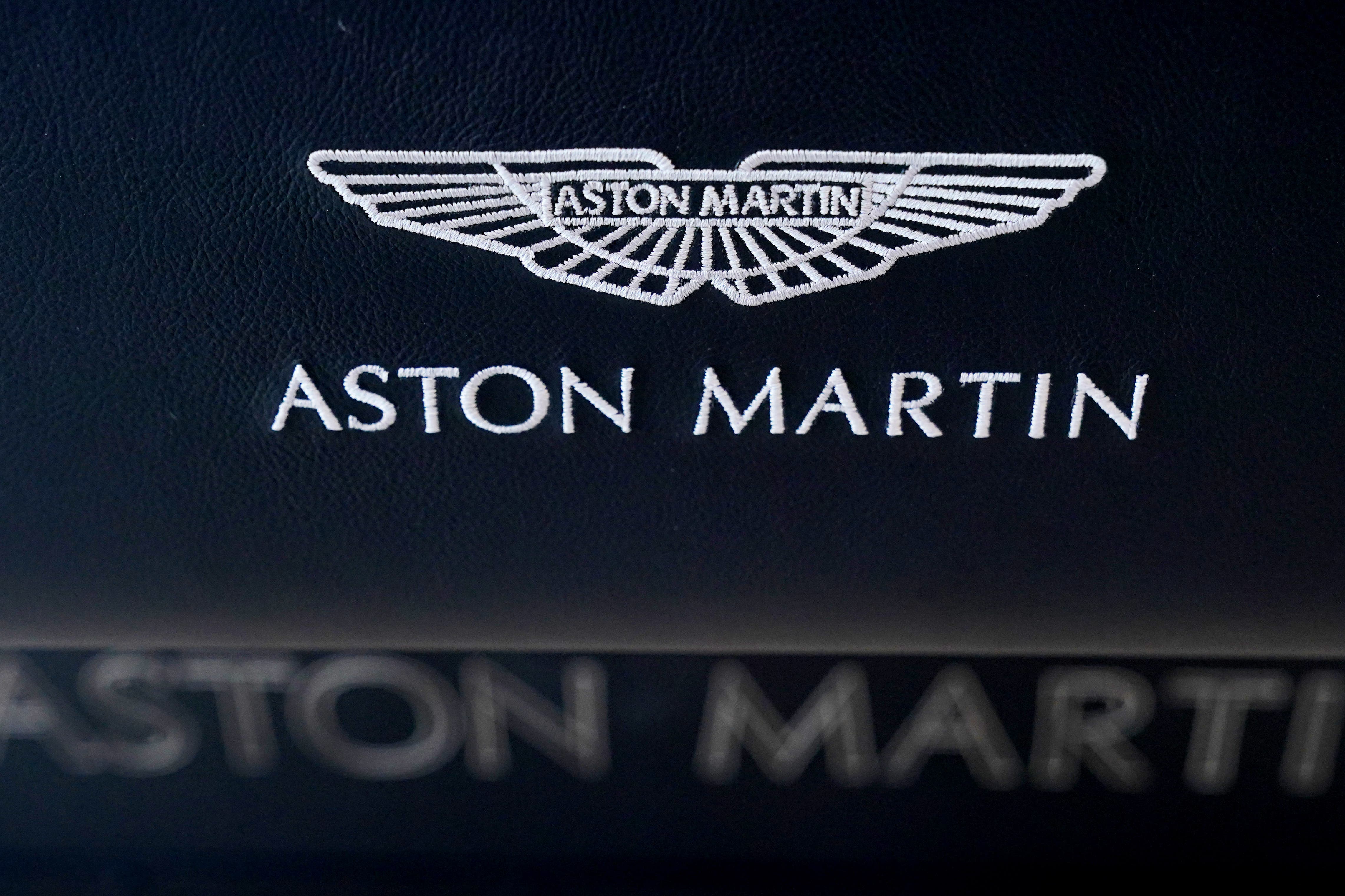 Luxury carmaker Aston Martin Lagonda has cut its full-year outlook after revealing widened first half losses as trade tariff woes took their toll (PA)