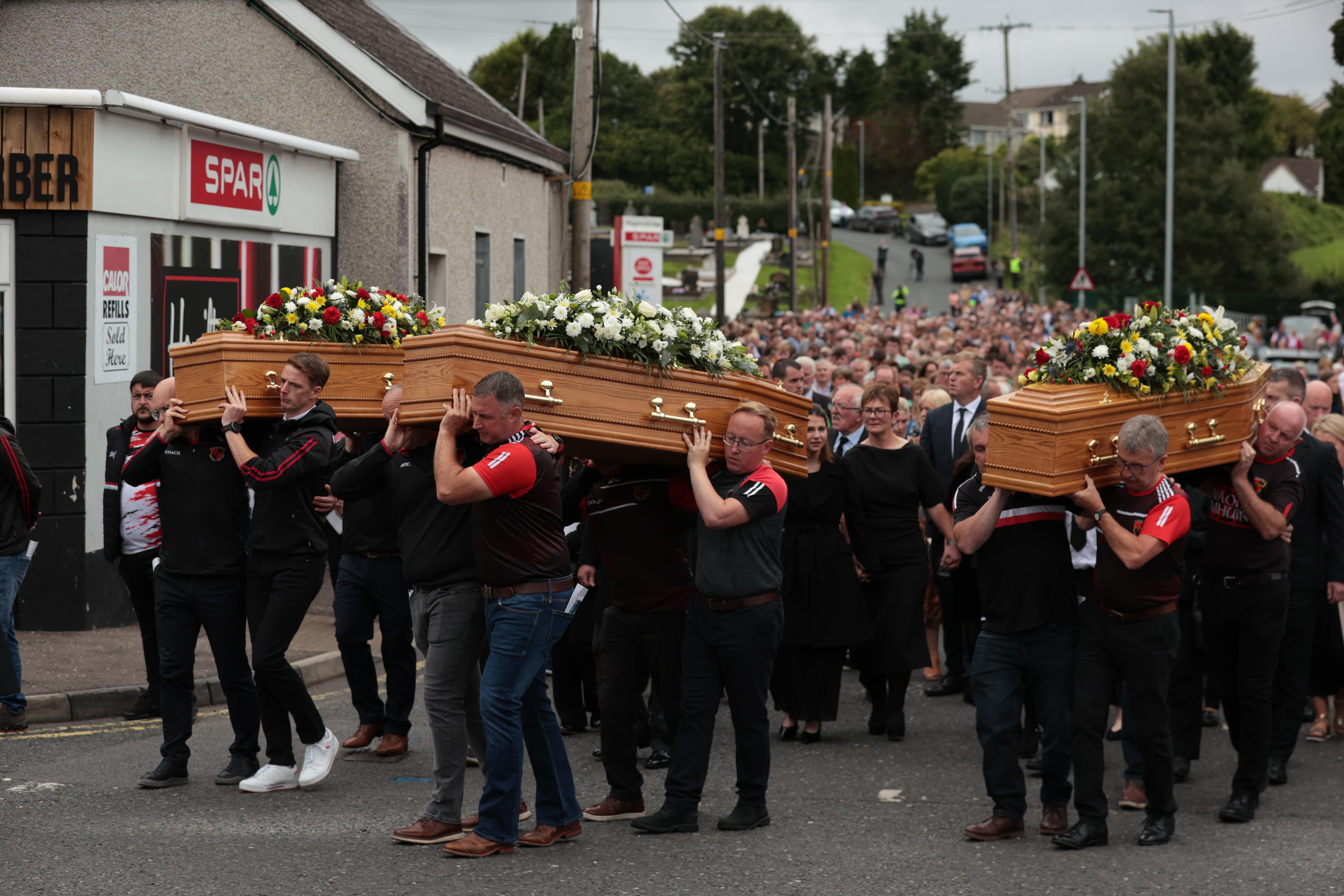 The coffins of murder victims Vanessa Whyte and her children Sara and James Rutledge are carried from St Mary’s Church in Maguiresbridge, Co Fermanagh, following a service of removal (Liam McBurney/PA)