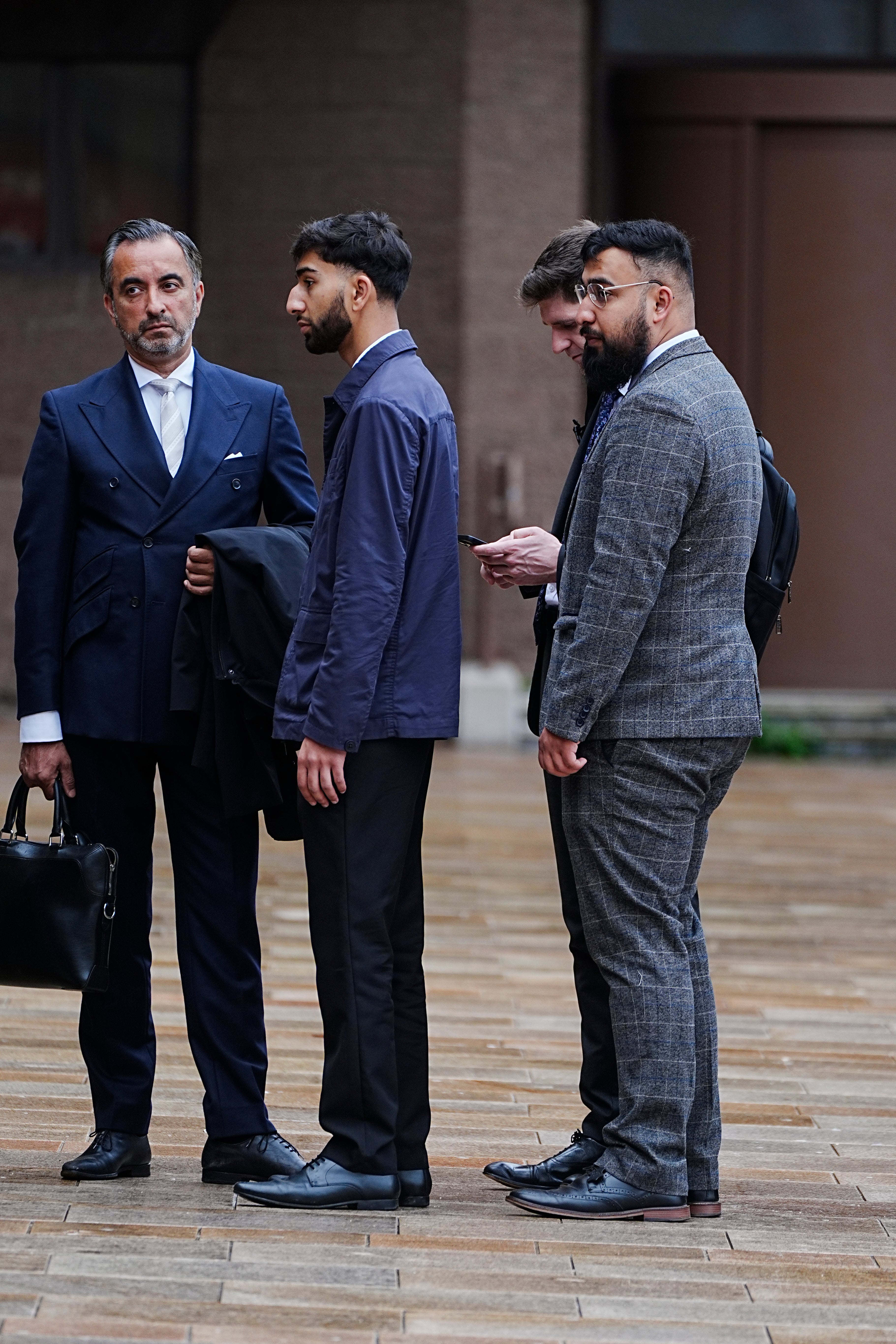 Human rights lawyer Aamer Anwar (left) arrives with Mohammed Fahir Amaaz (centre) and Muhammad Amaad (right) at Liverpool Crown Court