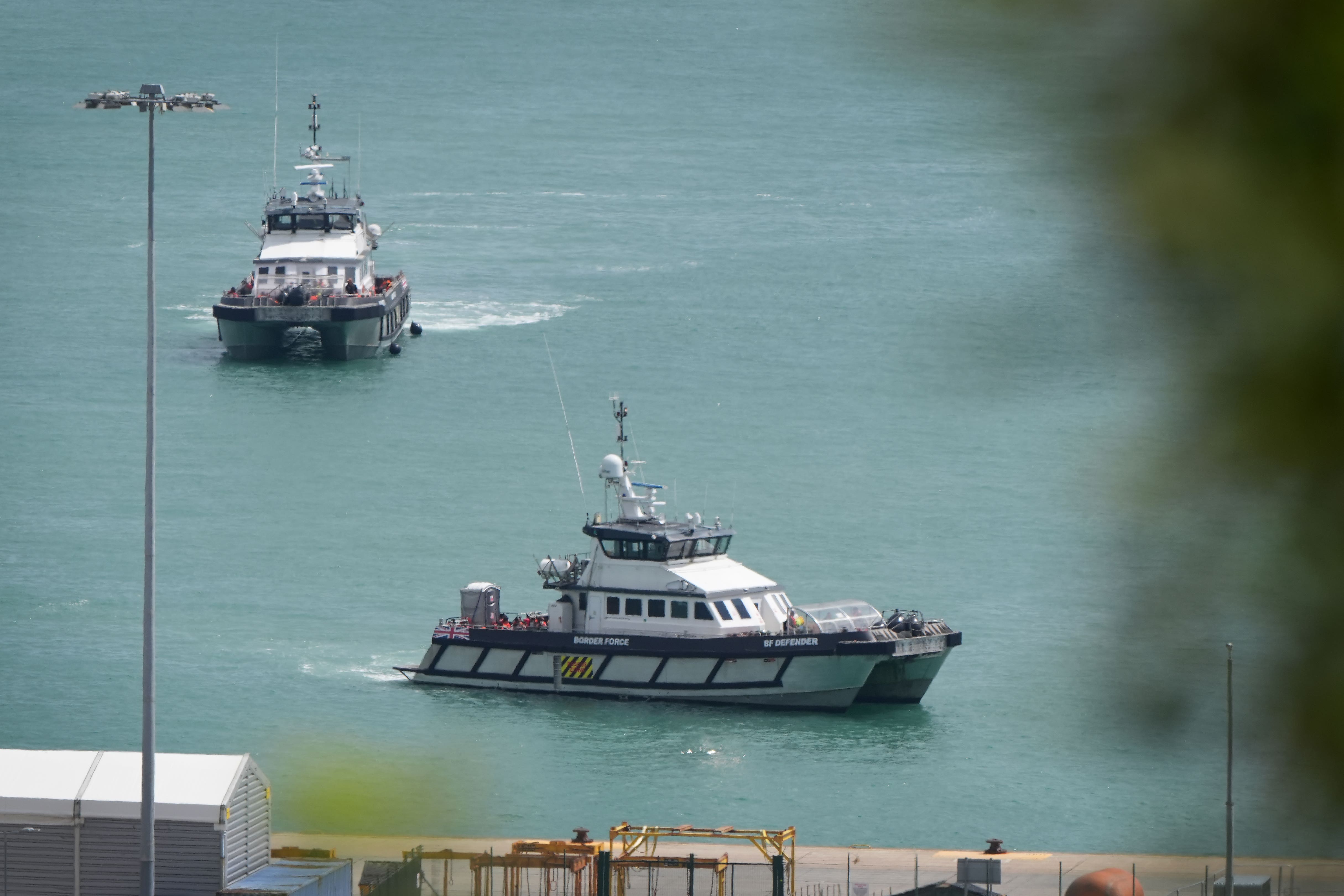 A group of people thought to be migrants are brought in to the Border Force compound in Dover (Gareth Fuller/PA)