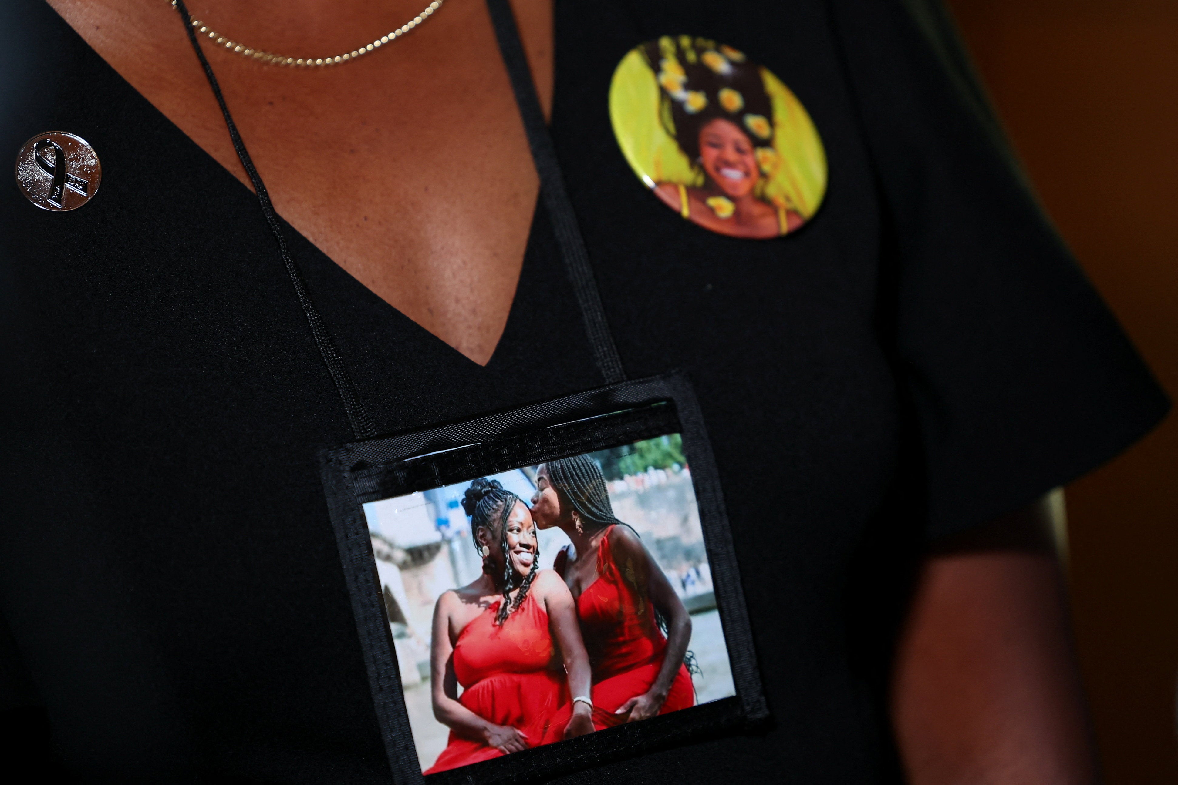 A victim's relative wears an image on her neck during the hearing