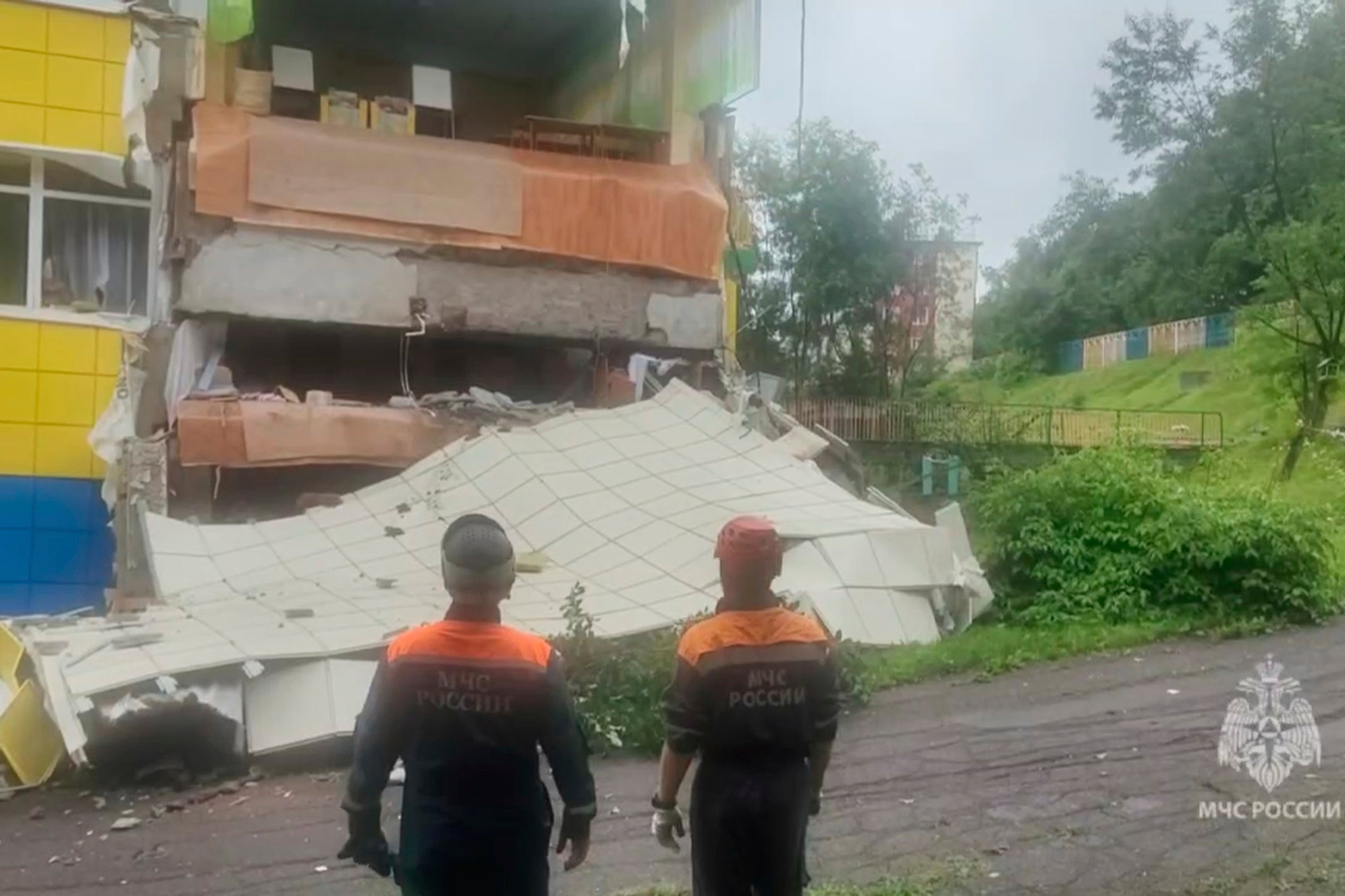 Rescuers inspect a kindergarten damaged by an earthquake in Petropavlovsk-Kamchatsky, Russia