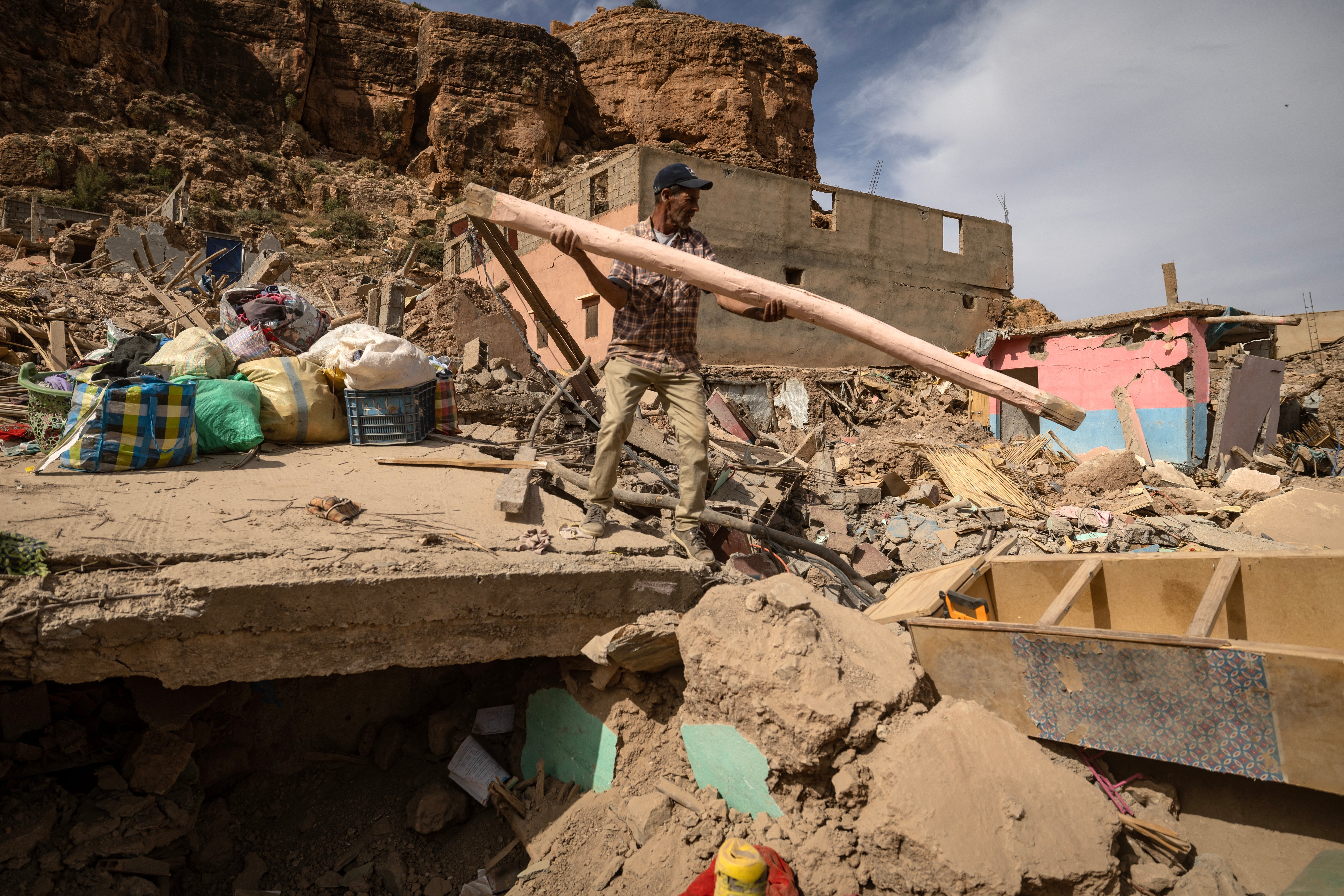 A man searches through the rubble in the earthquake-hit village of Imi N'Tala, in central Morocco on October 5, 2023