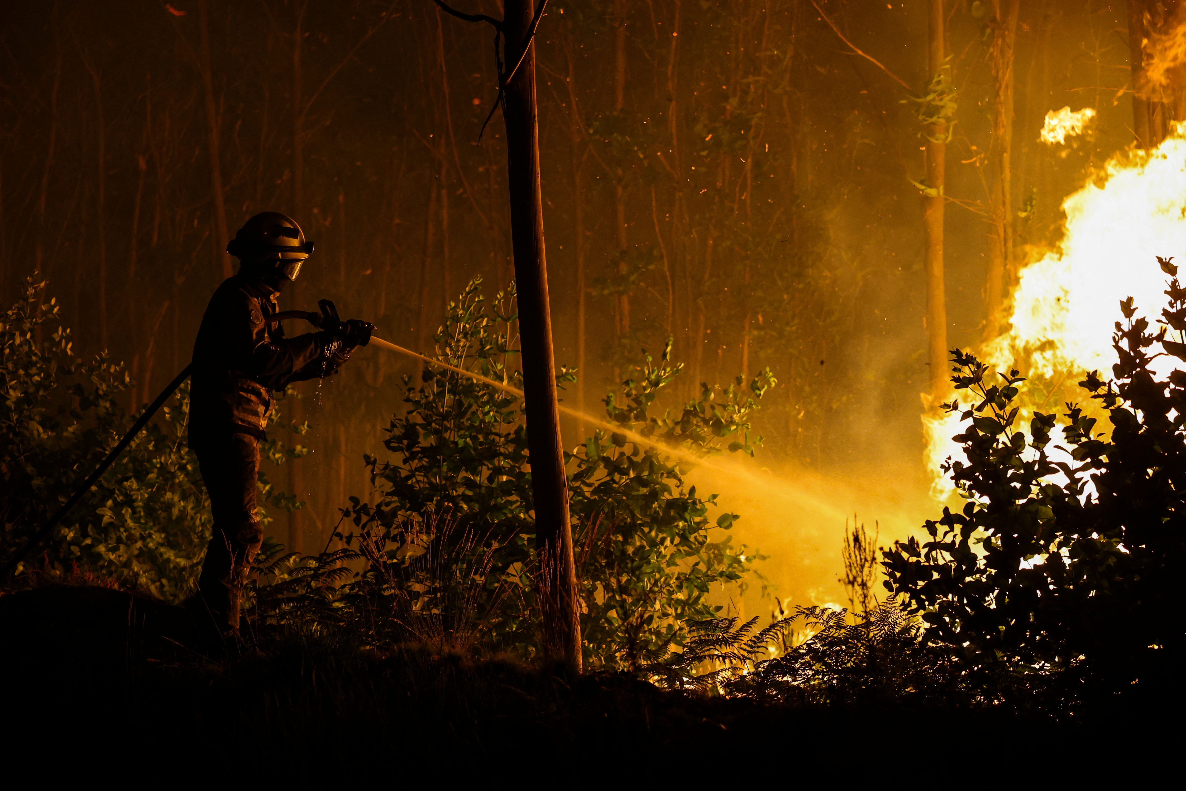 A firefighter works on a wildfire in Arouca, northern Portugal on July 30, 2025