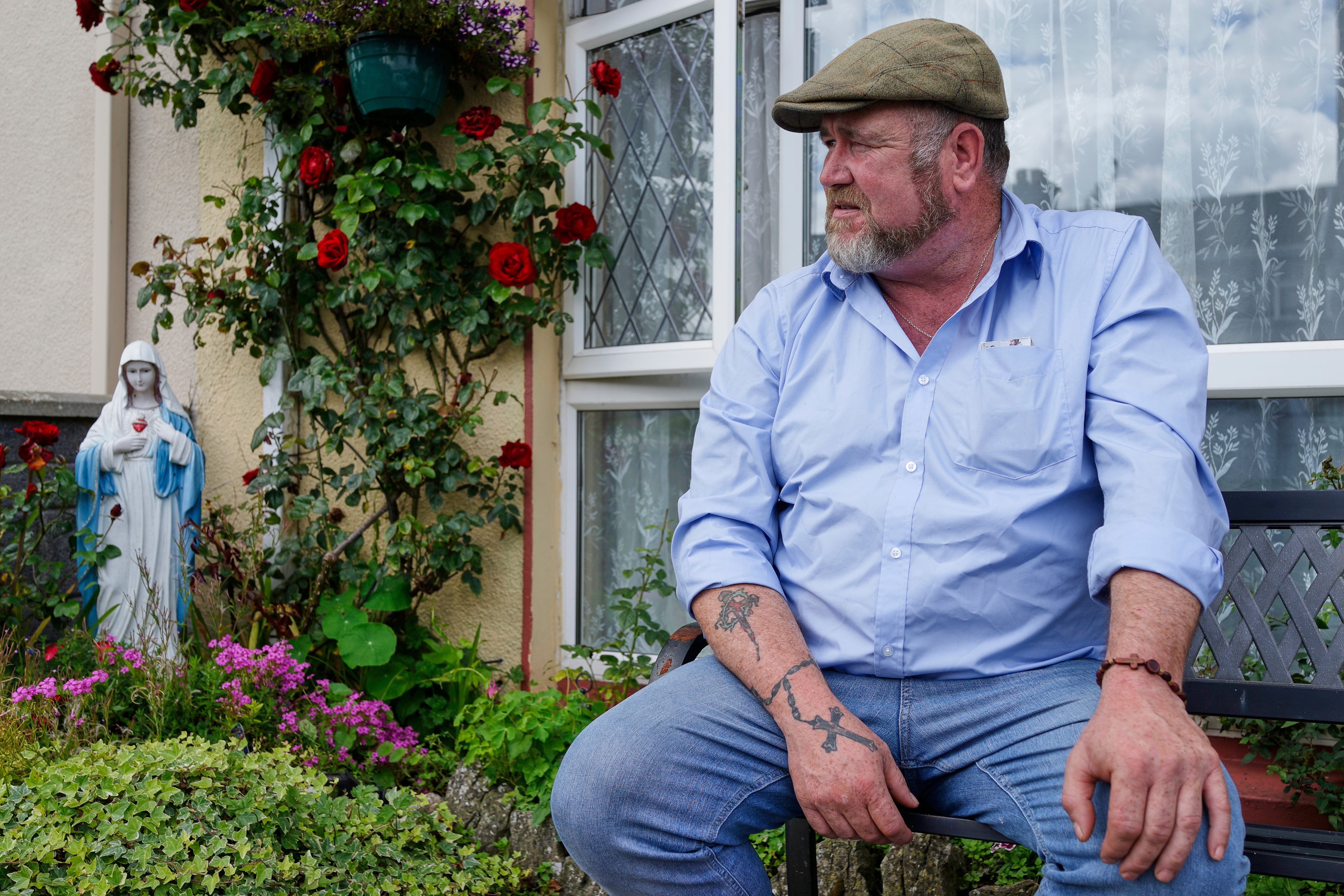 Patrick McDonagh, who grew up in the neighborhood built atop the former mother and baby home in Tuam, Ireland, sits outside his family's home on Tuesday, July 8, 2025