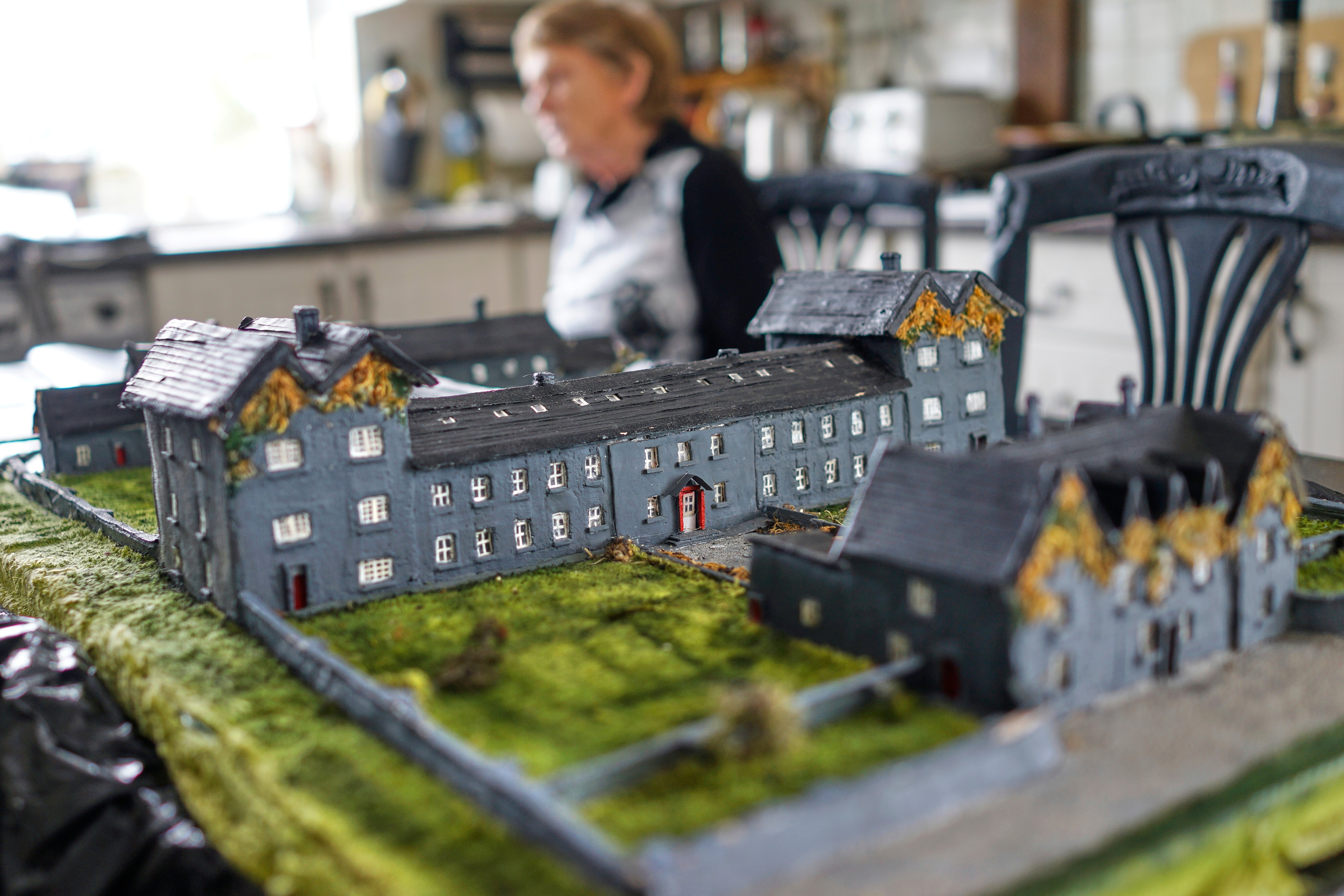 Catherine Corless, who discovered that nearly 800 children died at a mother and baby home in Tuam, Ireland, is seen with a replica she built of the home Tuesday, July 8, 2025. (AP Photo/Brian Melley)