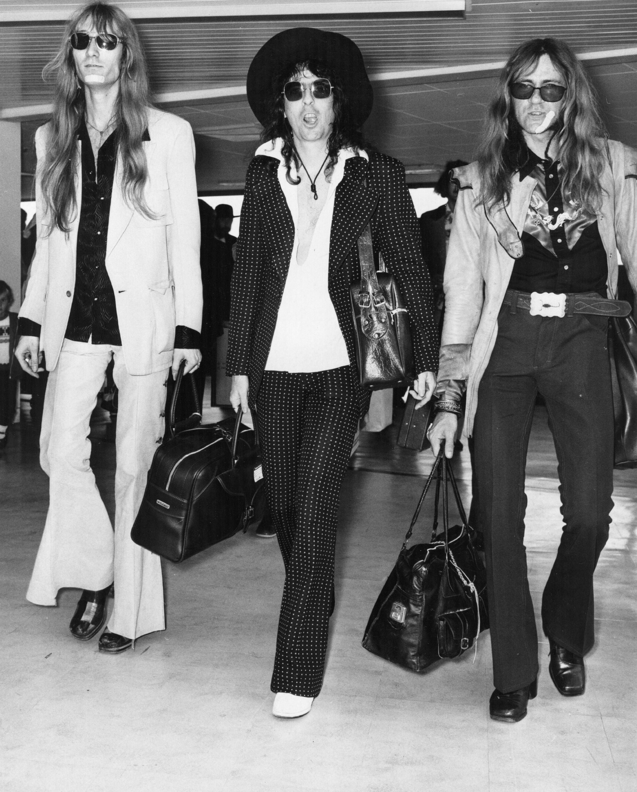 Alice Cooper (centre) and his bandmates arriving at London airport, 4 July 1972