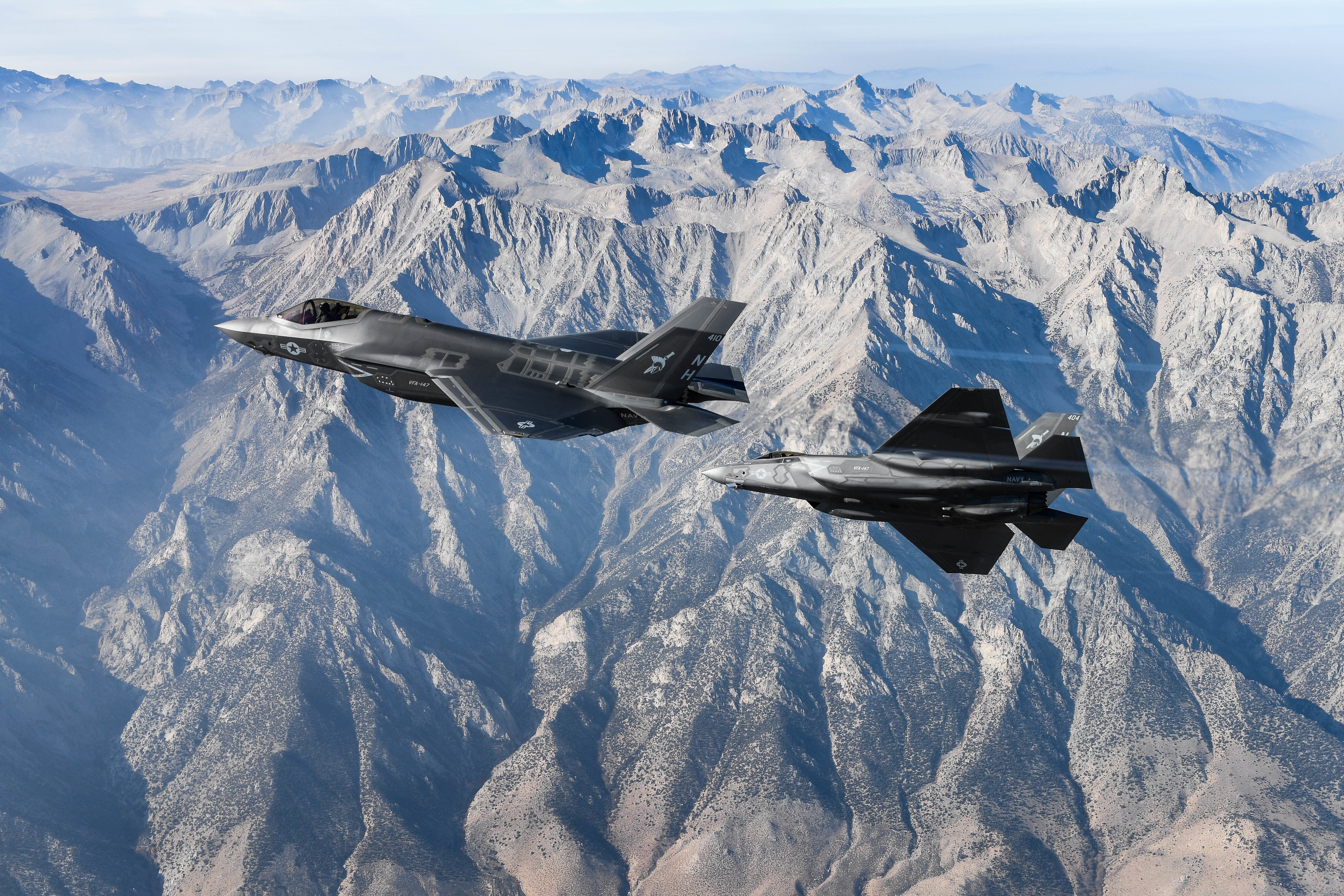 Two F-35C Lightning II, attached to the “Argonauts” of Strike Fighter Squadron (VFA) 147, stationed at Naval Air Station Lemoore, fly in formation for a photo exercise in 2018