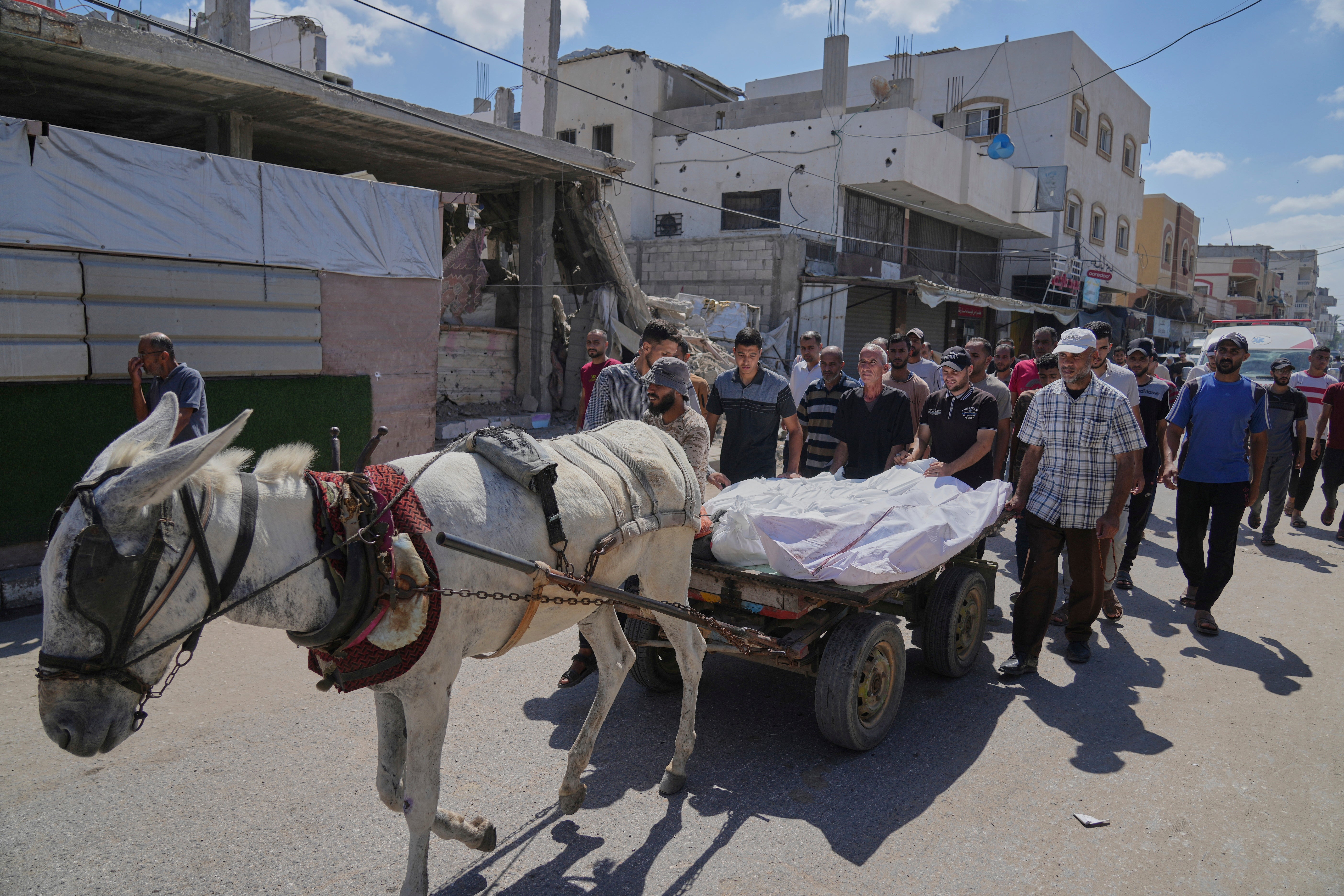 Mourners attend the funeral of their relatives killed in an Israeli bombardment, in Deir al-Balah, central Gaza Strip, Thursday, July 31