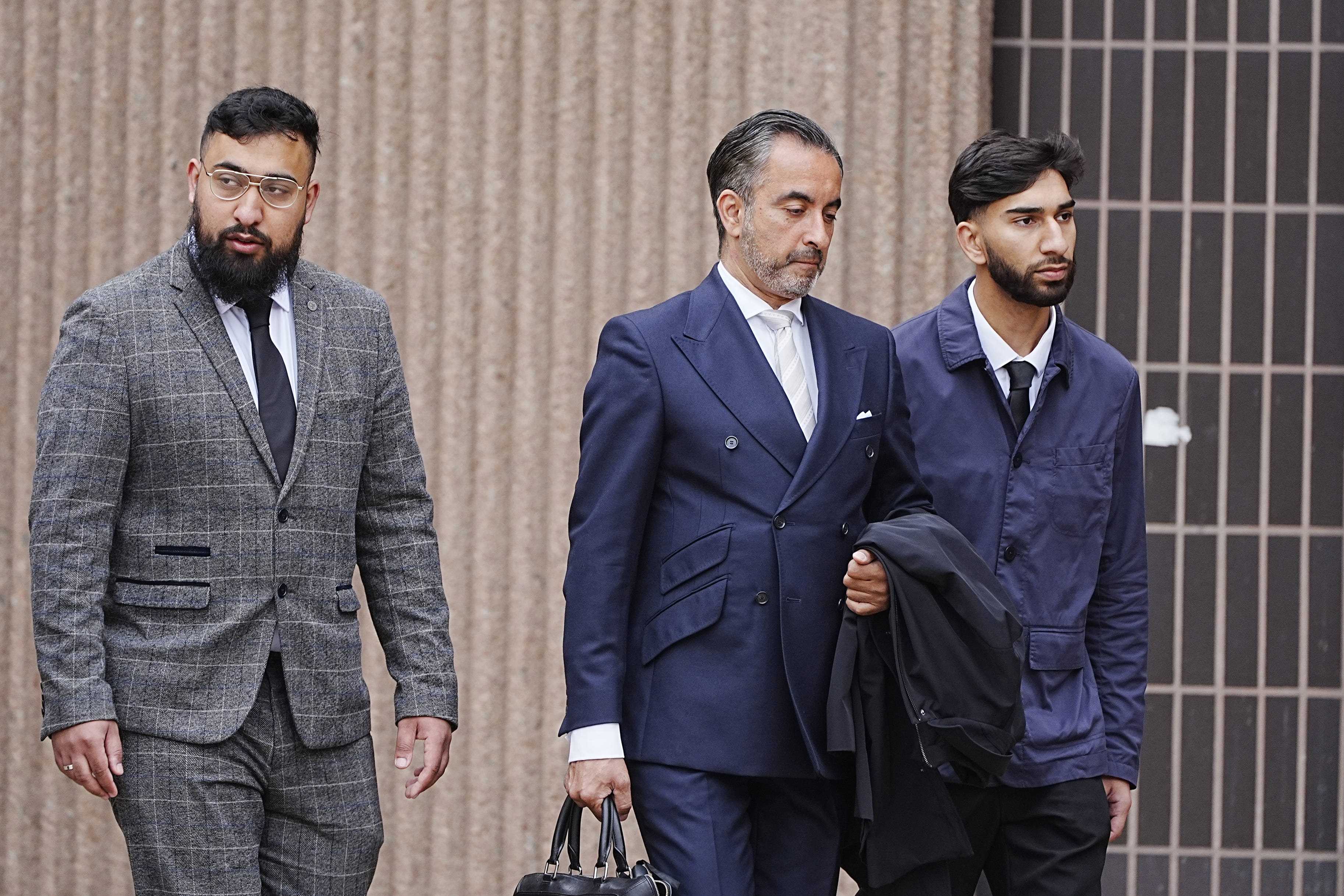 Aamer Anwar (centre) arrives at Liverpool Crown Court with Muhammed Amaad (left) and Mohammed Fahir Amaaz (right)