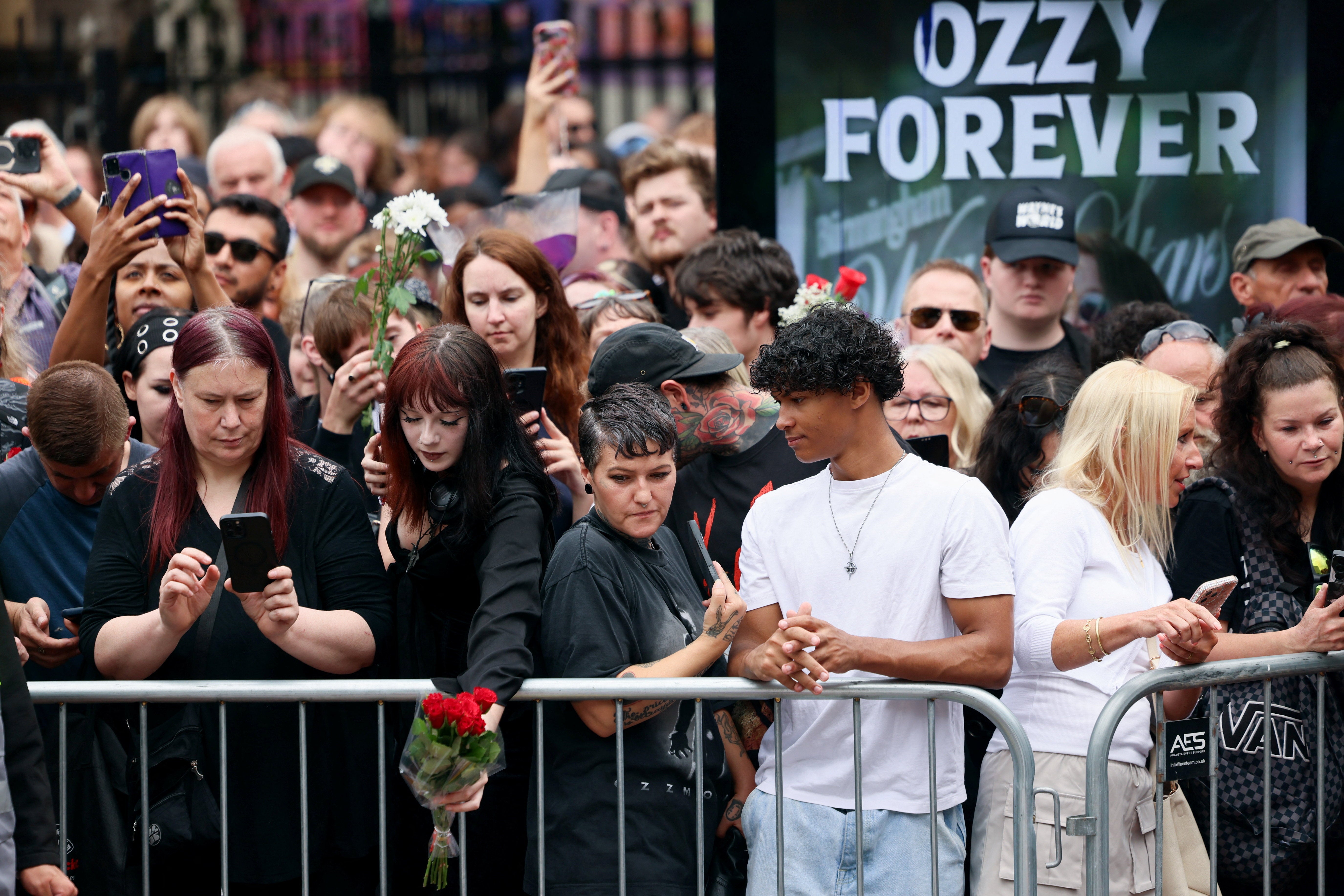 People gather on the day of the funeral cortege of Ozzy Osbourne in Birmingham, Britain