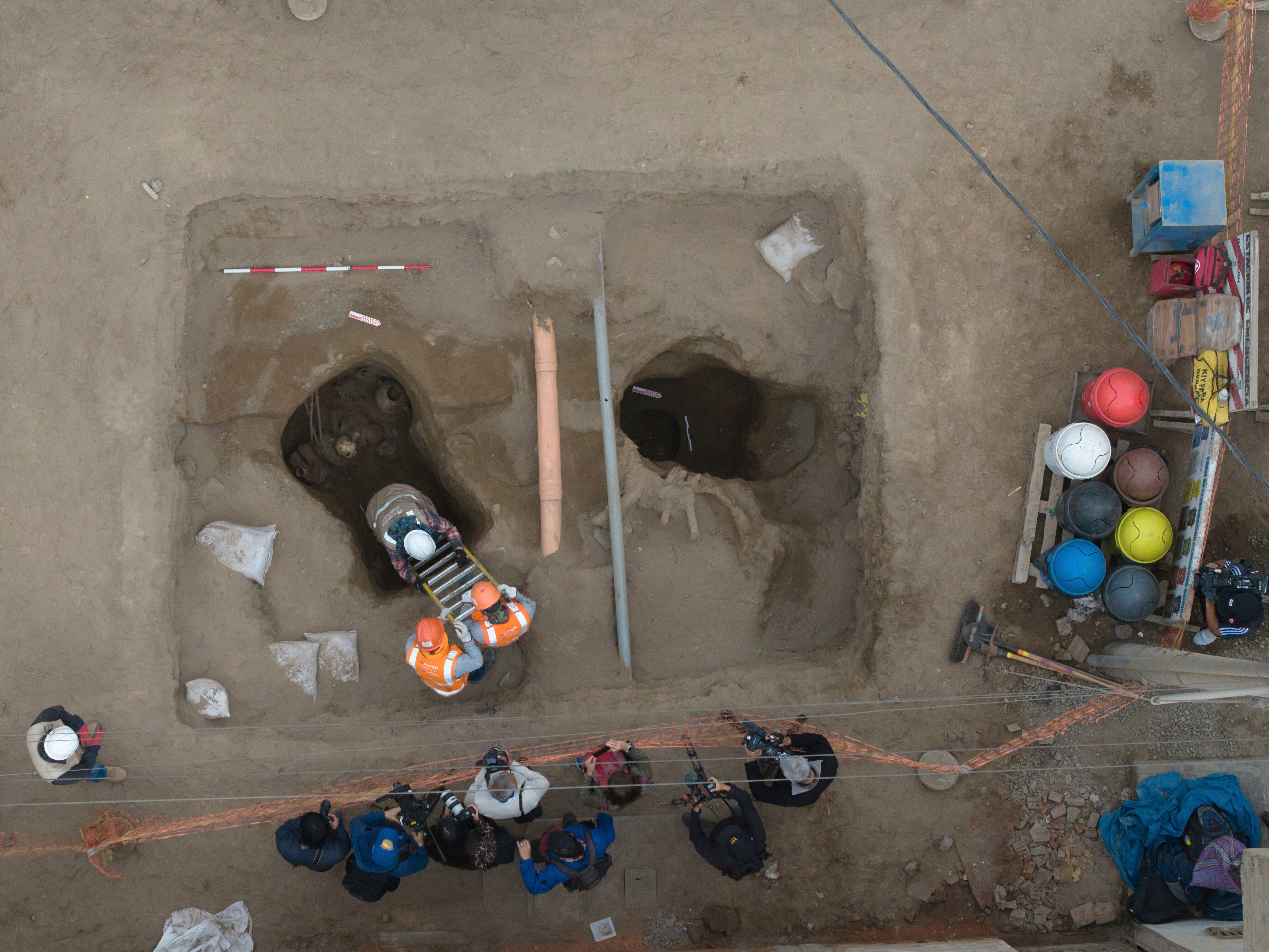 Archaeologist work at the site where city workers discovered ancient remains, from the pre-Inca Chancay culture, and artifacts as they were digging a natural gas line