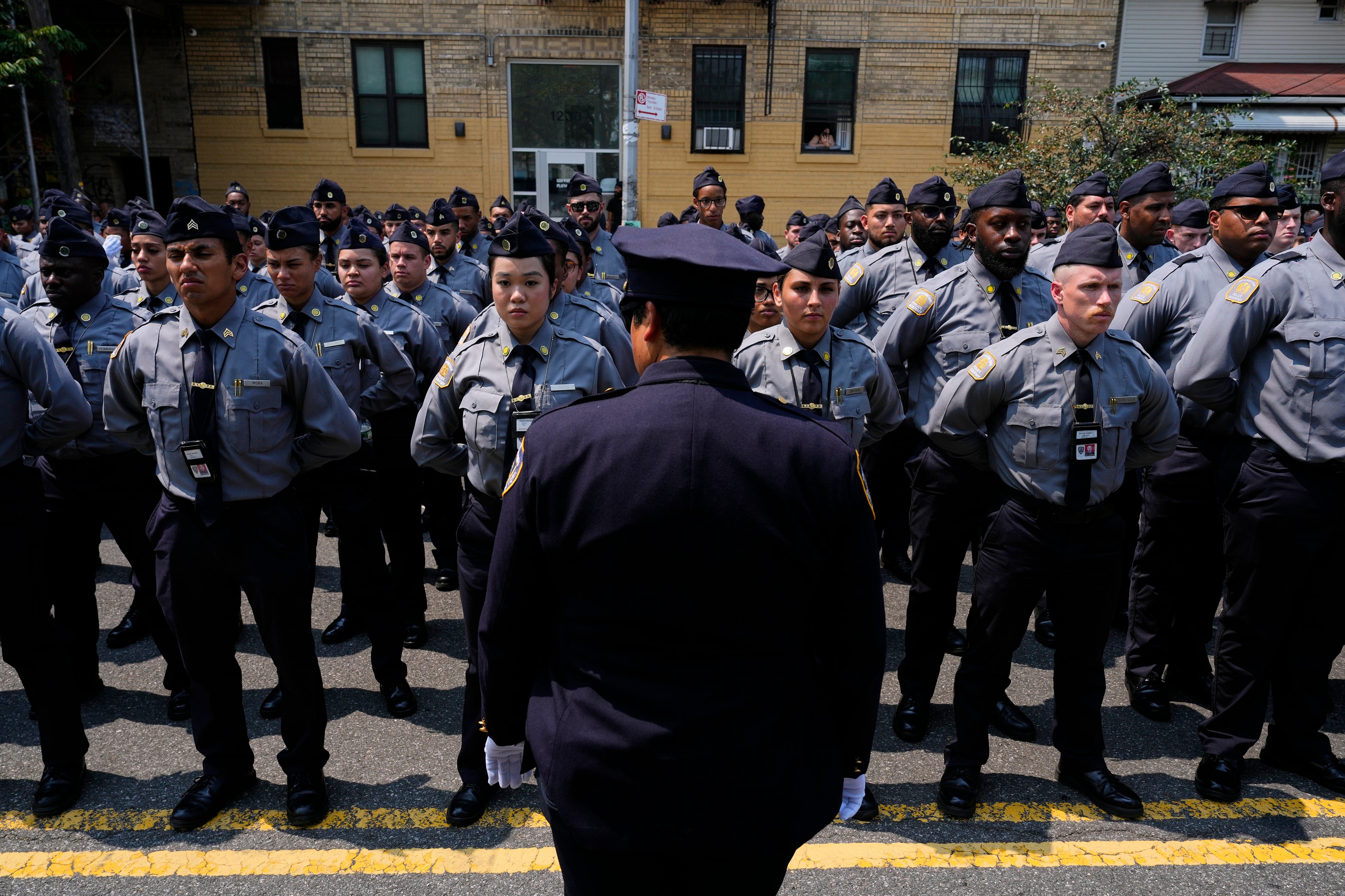 New York Police Academy cadets line the street outside the Parkchester Jame Masjid mosque for the funeral