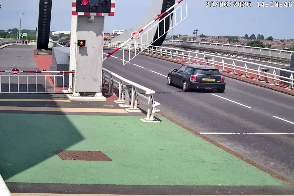 A driver drives through red warning lights at Lowestoft’s Gull Wing Bridge. (Suffolk County Council/ PA)