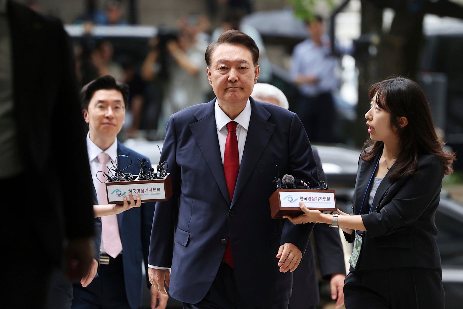 FILE - Former South Korean President Yoon Suk Yeol, center, arrives at a court to attend a hearing to review his arrest warrant requested by special prosecutors in Seoul, South Korea, July 9, 2025