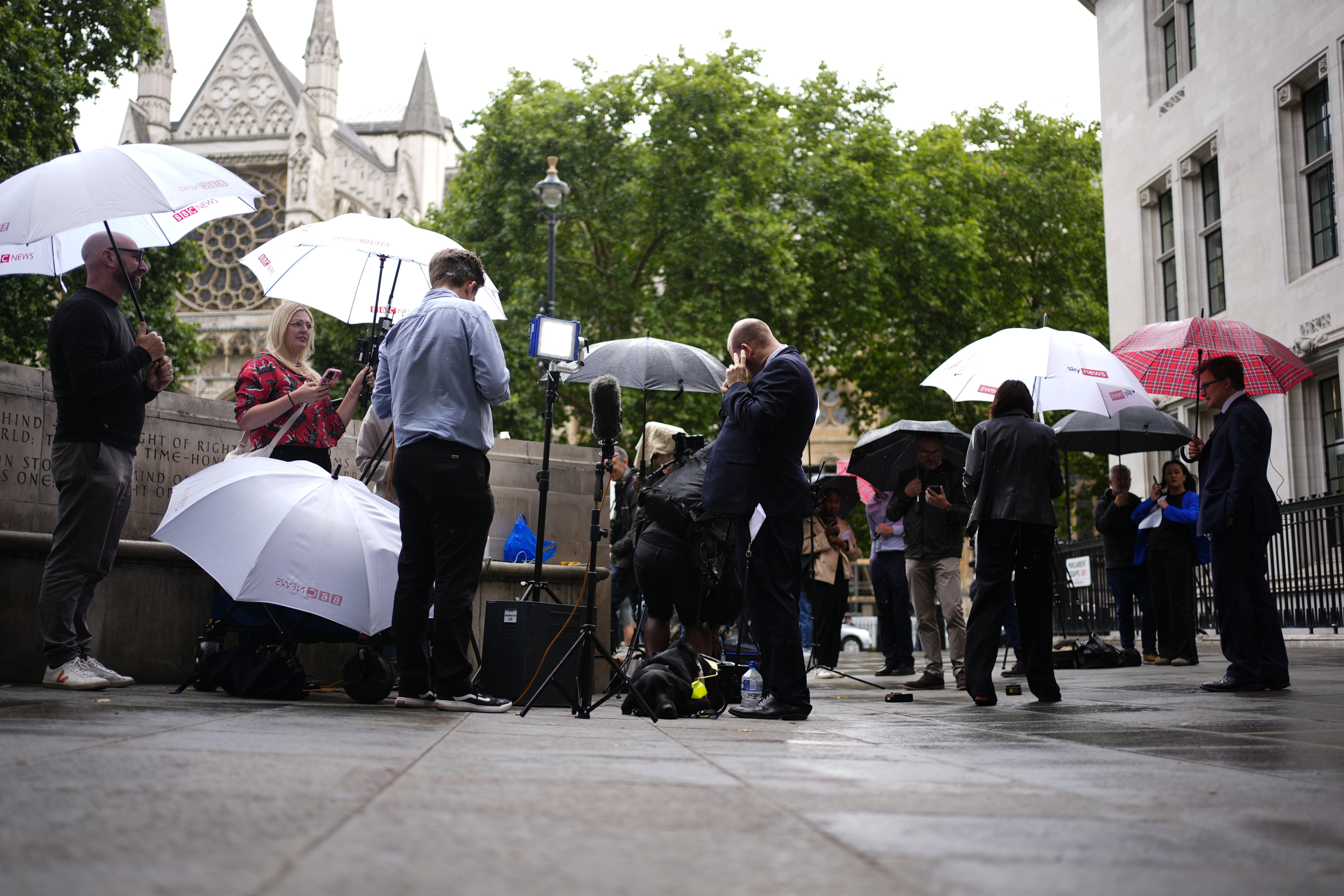 Members of the media report from outside the Supreme Court in London on the day of the ruling