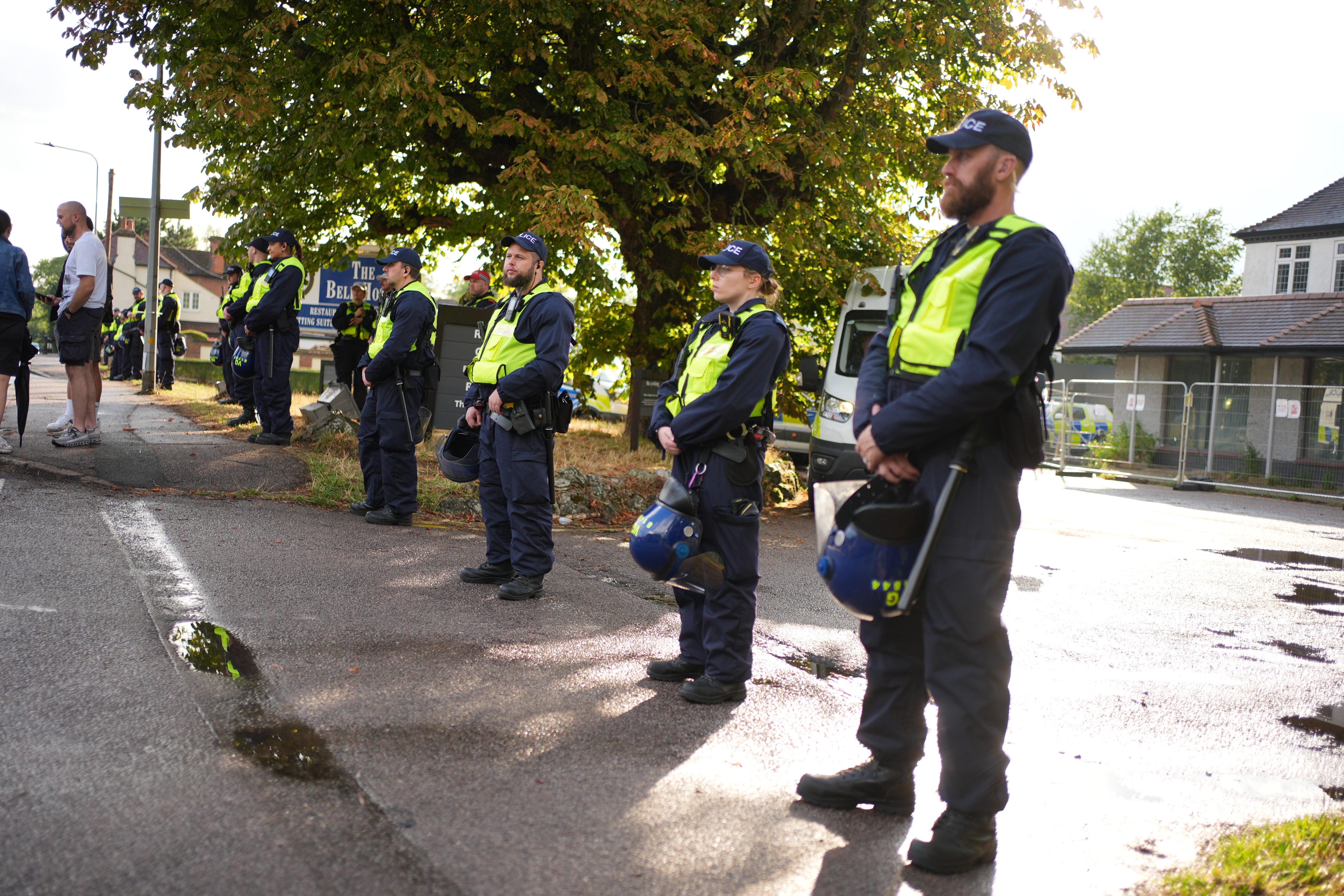 Police officers watch protesters outside the former Bell Hotel in Epping, believed to be housing asylum seekers, where there have been a number of demonstrations (Yui Mok/PA)