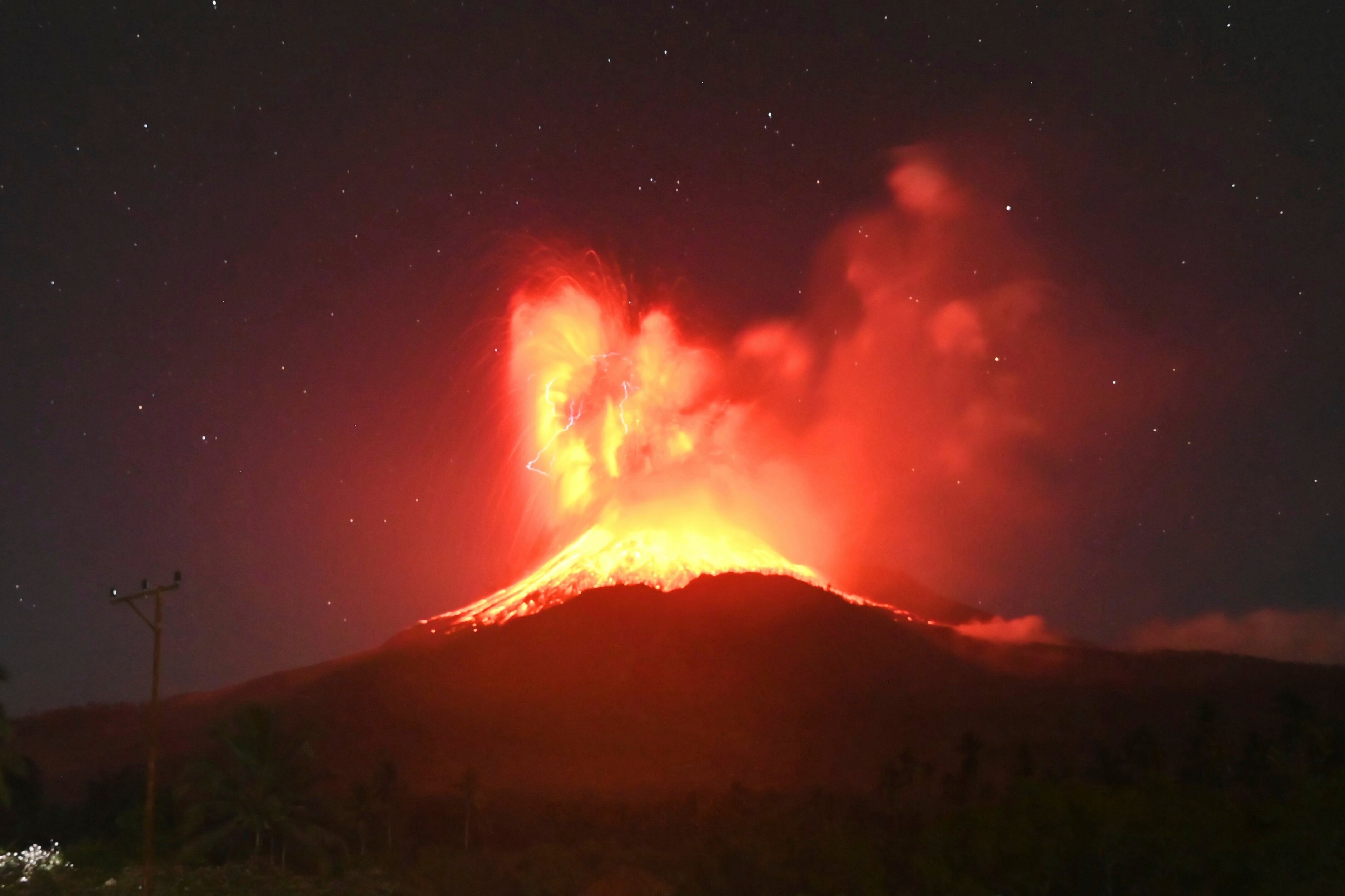 Lava glows on the slope of Mount Lewotobi Laki-Laki during an eruption on Friday evening