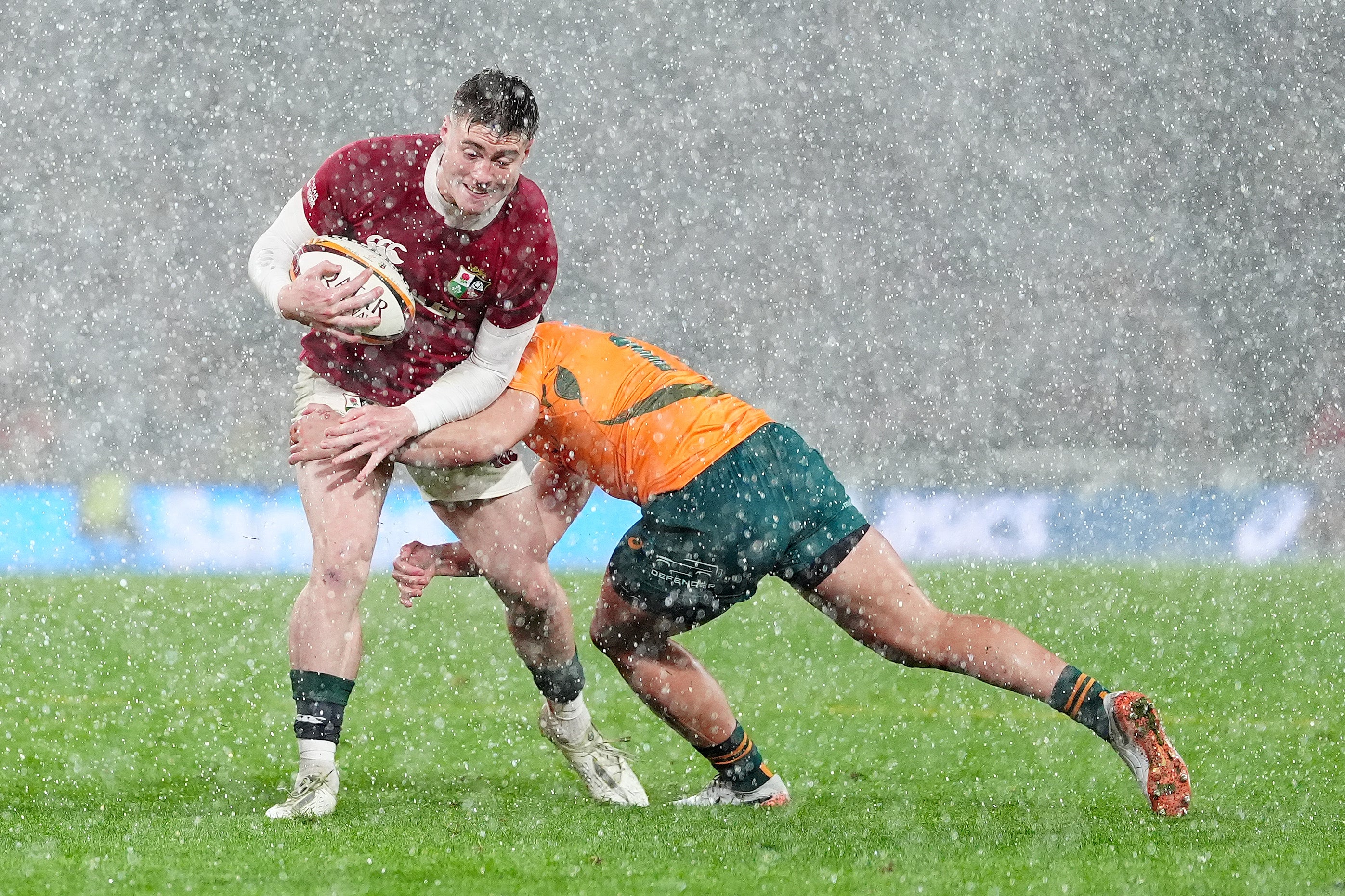 British and Irish Lions' Tommy Freeman (left) is tackled by Australia's Tom Wright during the Qatar Airways Lions Tour match at Accor Stadium