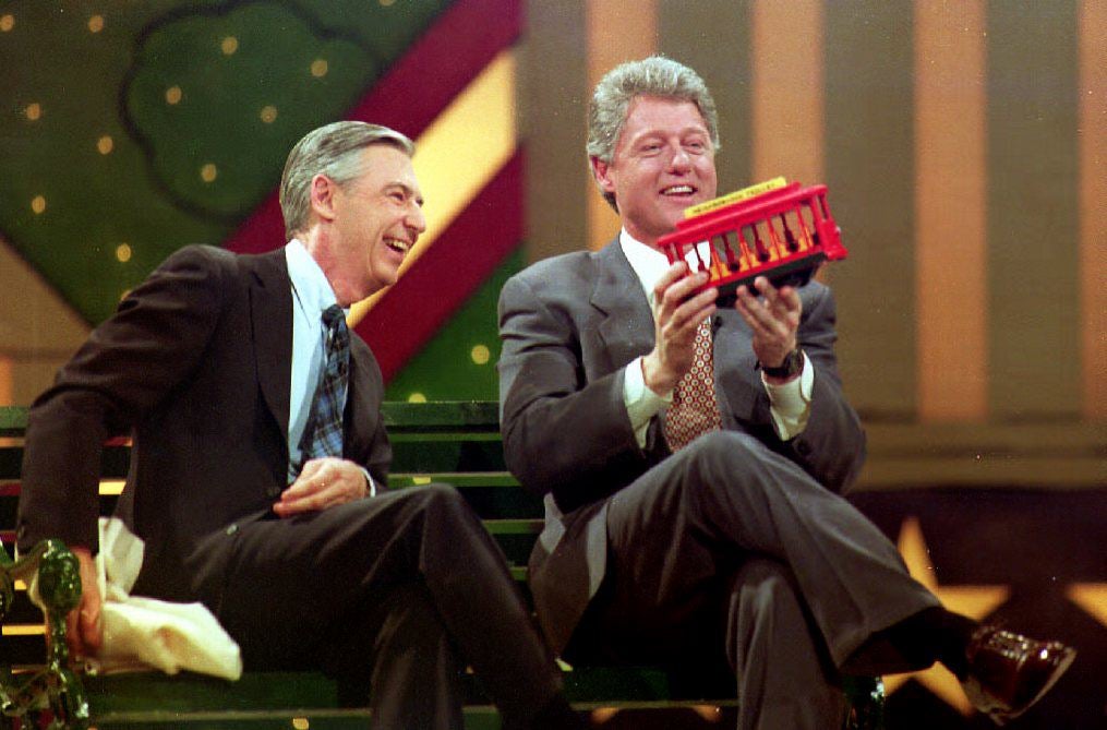 U.S. President-elect Bill Clinton held a trolley car given to him by Fred Rogers