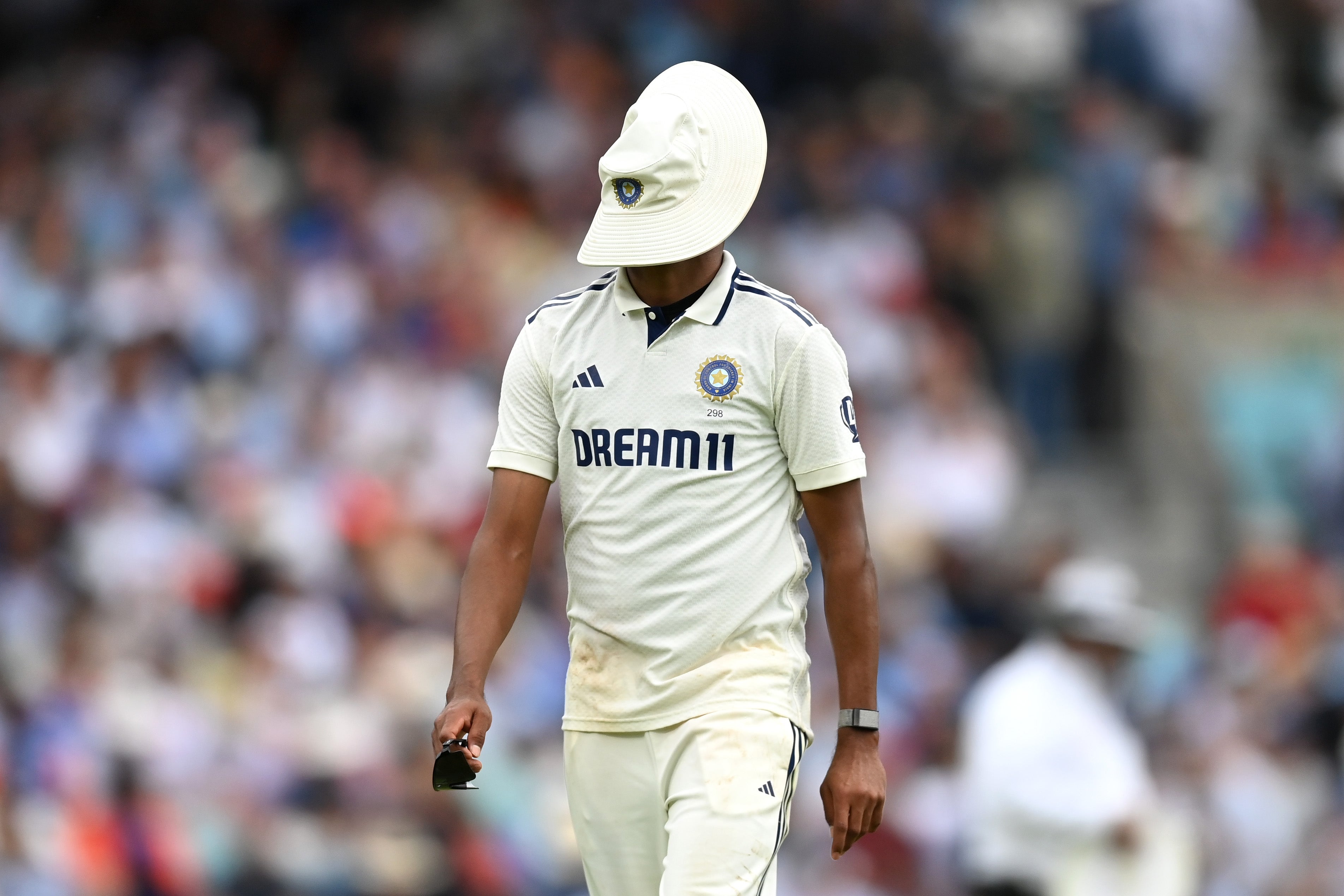 Mohammed Siraj of India puts his hat on his face after catching Harry Brook but carrying the ball over the boundary for a six