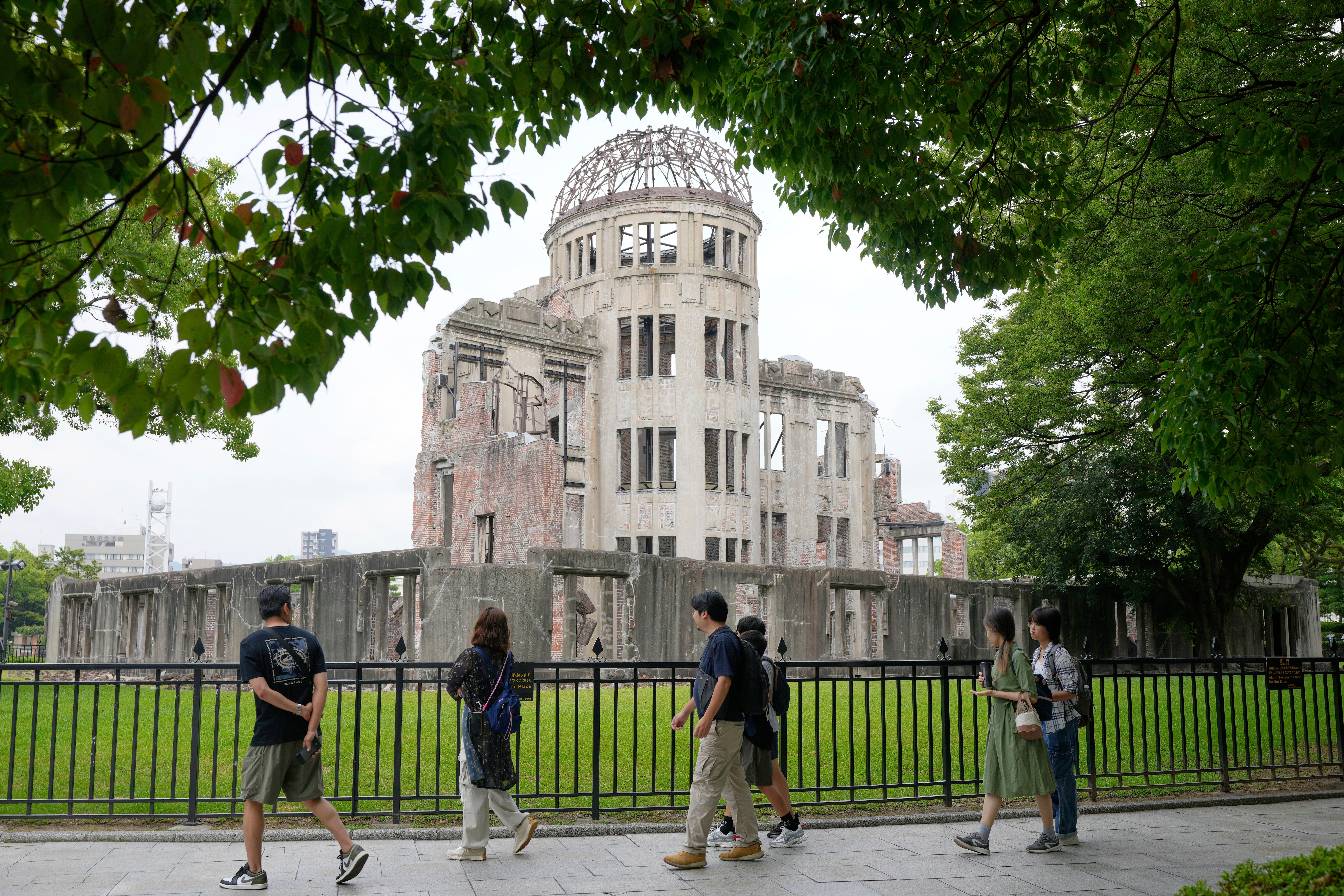 Tourists walk past the Atomic Bomb Dome in Hiroshima, western Japan