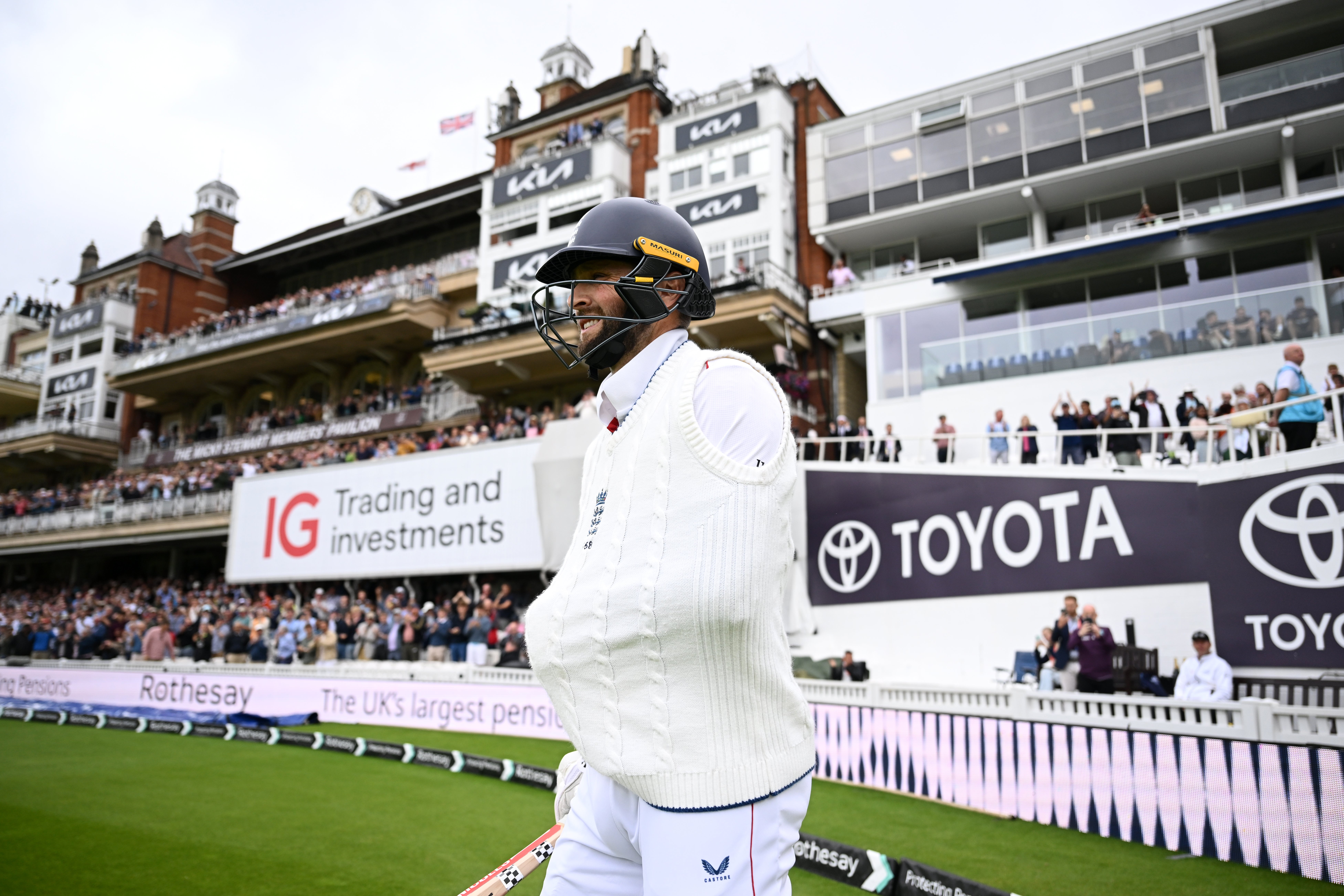 Chris Woakes walked out to play with his left arm in a sling