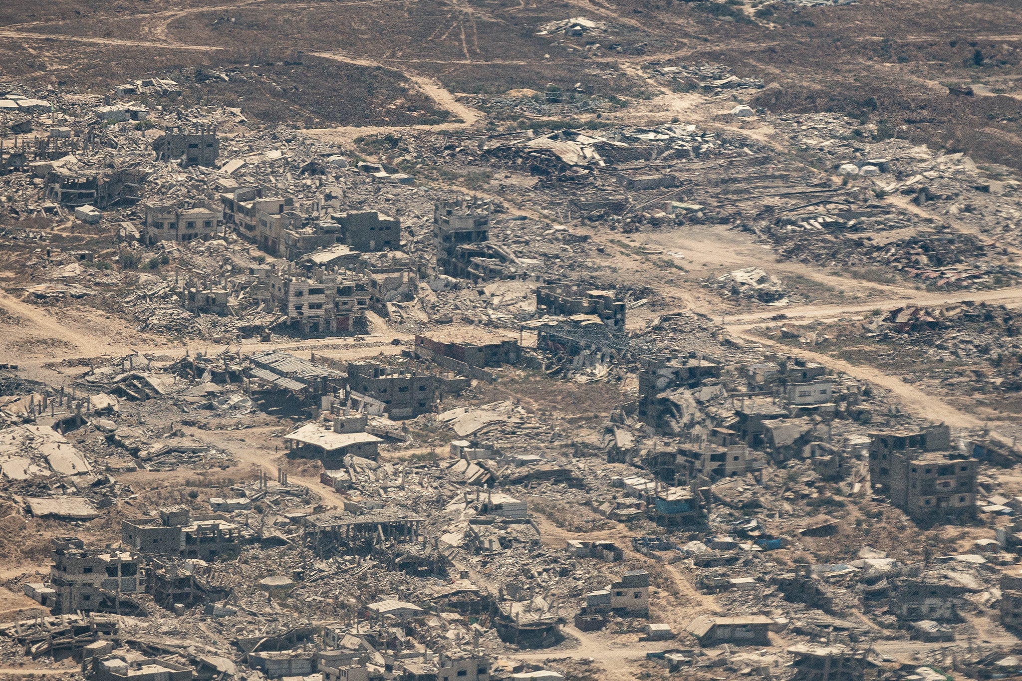 Aerial images taken during an aid drop flight over Gaza capture the scale of the destruction caused by almost two years of intense Israeli bombing