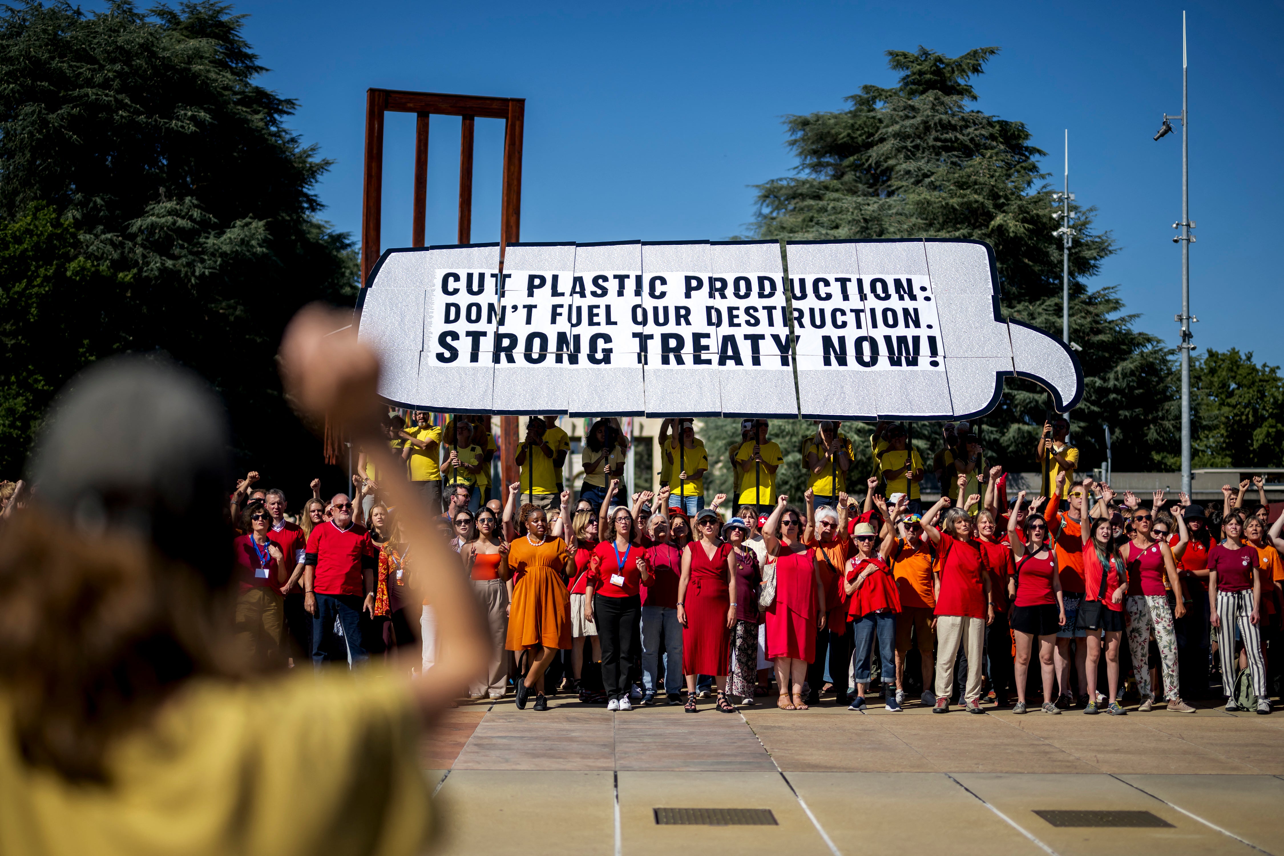 Activists protest in front of the United Nations Offices in Geneva, Switzerland, on Monday. Talks there aim to finalize the first global plastic pollution treaty