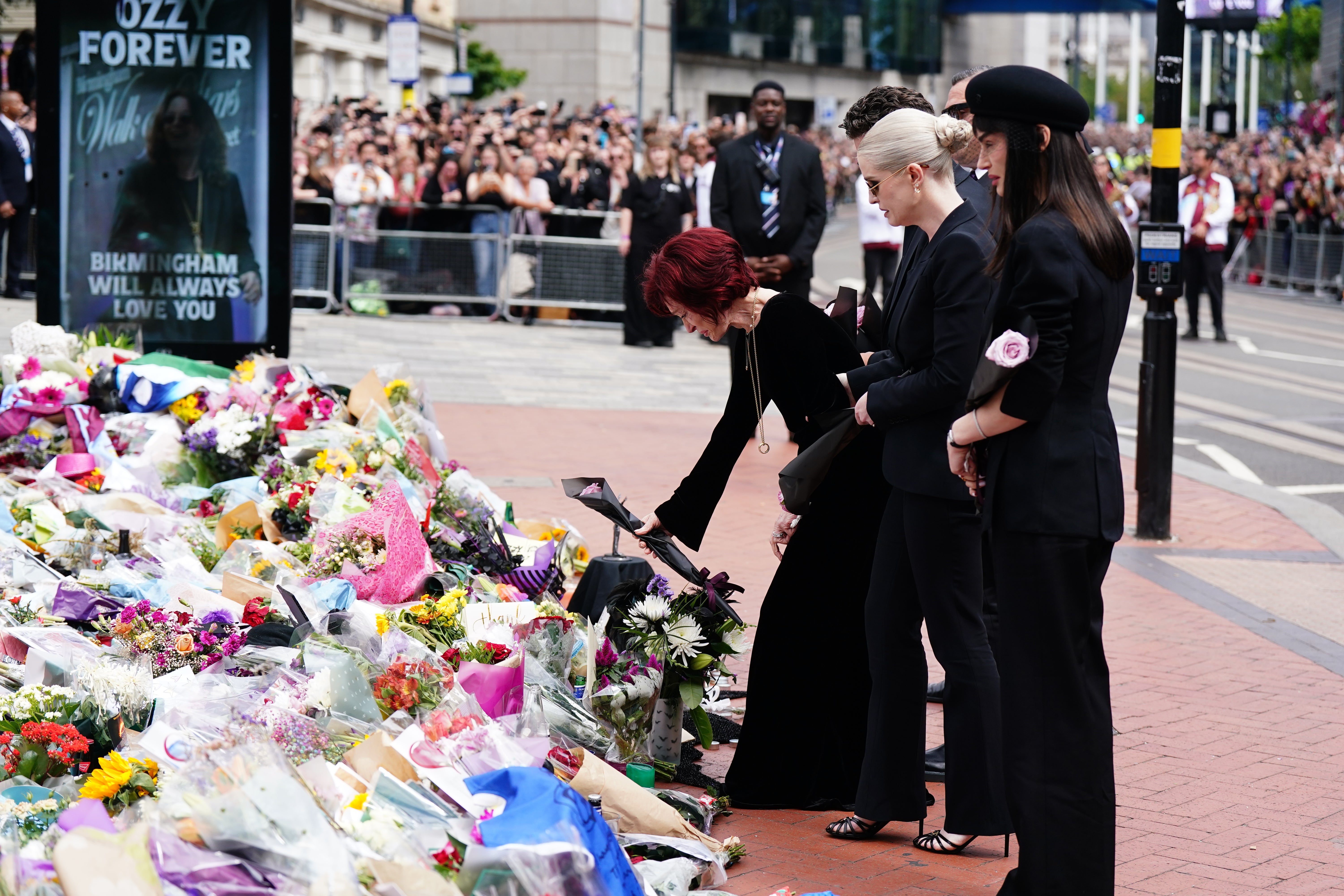 Kelly and her mother Sharon laying flowers at the Black Sabbath Bridge